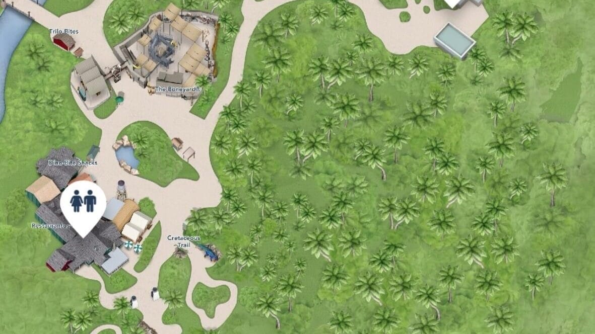 Map of a park featuring paths, palm trees, and labeled areas like "The Borrowers" and "Crackaxes Trail." A restroom icon is visible near the "Blue Billabong." Enhance your visit with My Disney Experience for real-time park details.