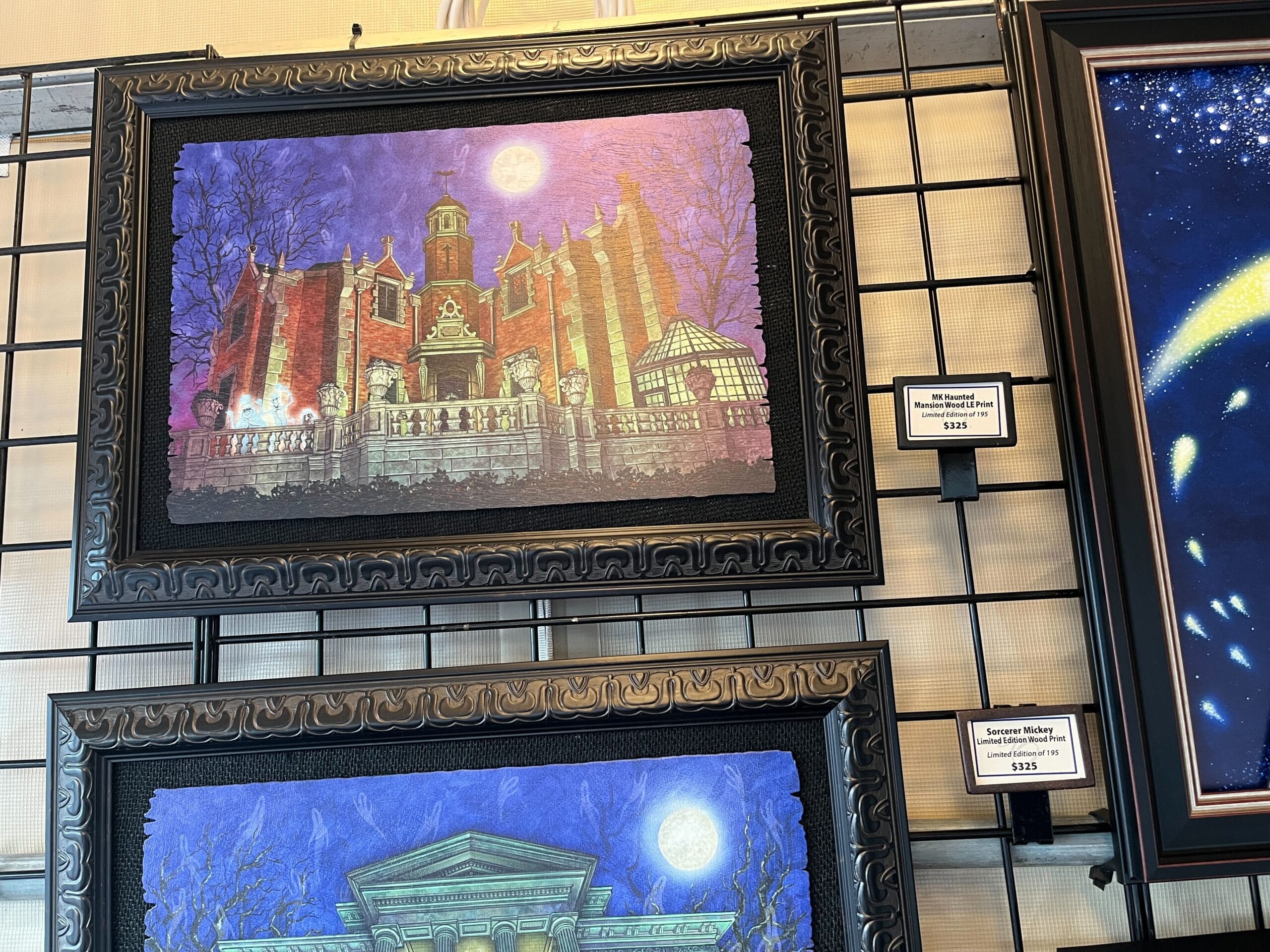Framed artwork of a castle under a full moon, reminiscent of EPCOT's 2025 Festival of the Arts, displayed on a grid wall. Price tag reads "$525.