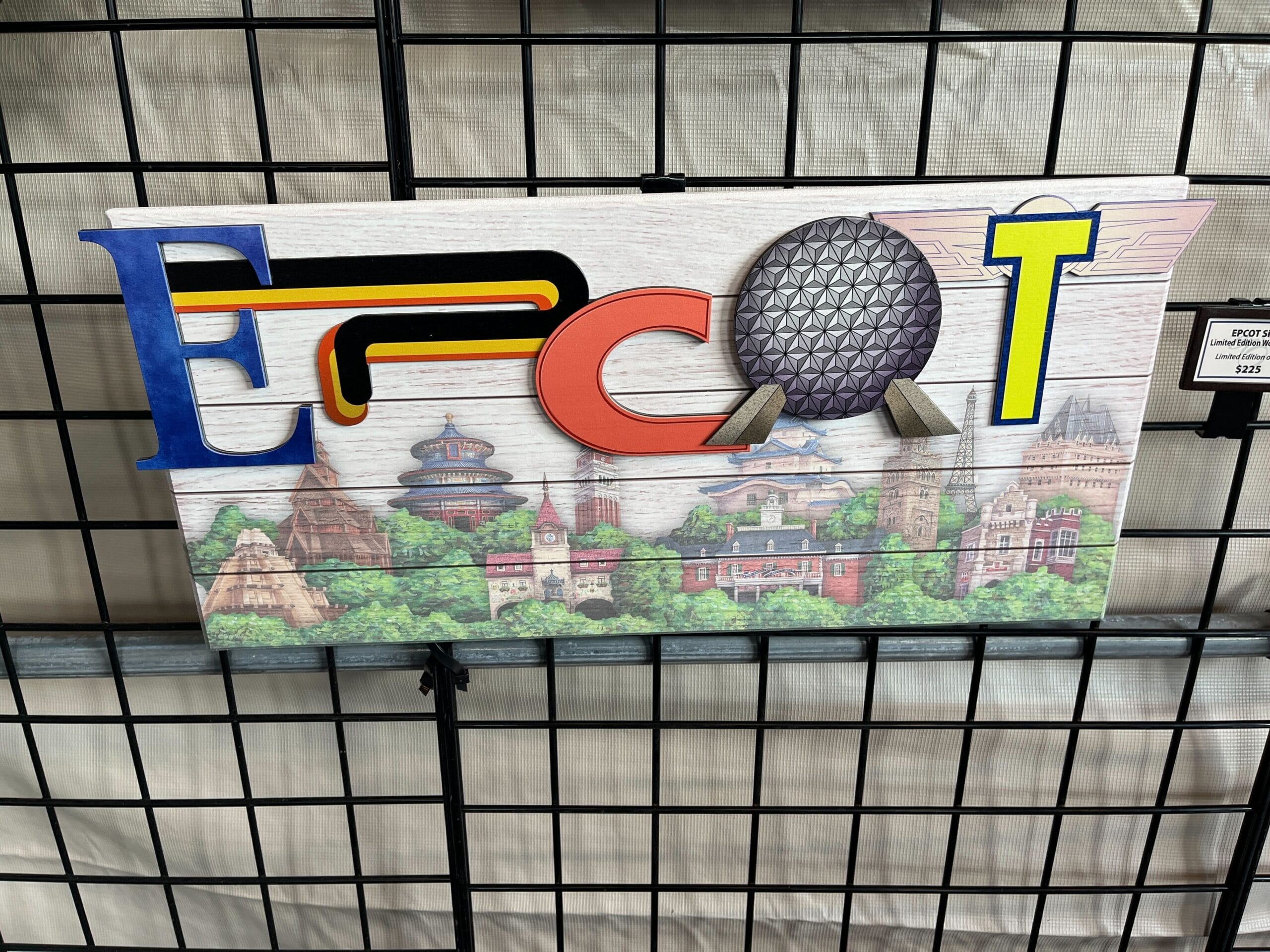 Artwork of the word "Epcot" with colorful letters and illustrations of landmarks behind, crafted by Dave Avazano, displayed on a wire grid. This vibrant piece captures the spirit of the EPCOT Festival of the Arts, perfect for envisioning its future in 2025.