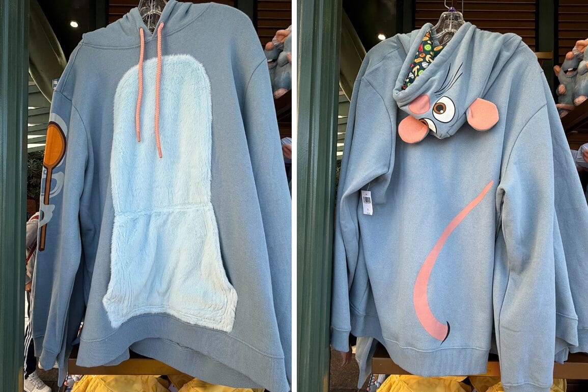 Front and back view of a blue hoodie with a plush white patch and spoon detail on the front, mouse ears and eyes on the hood, and a pink tail on the back.