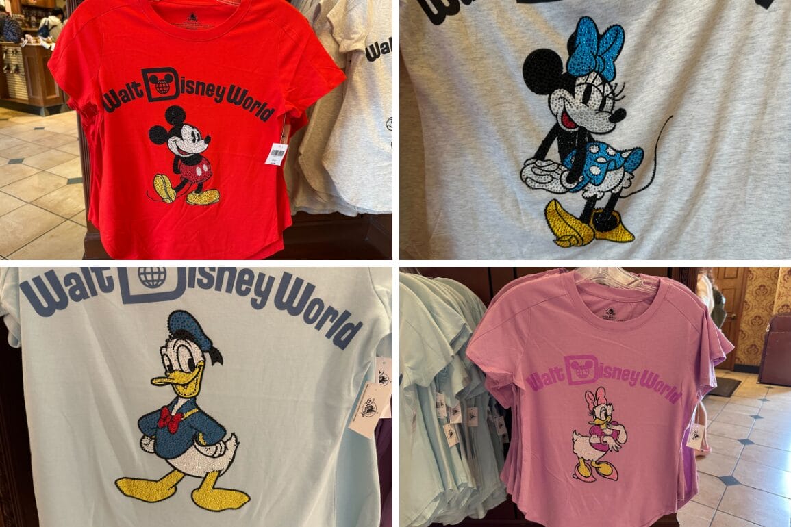 Four bedazzled shirts featuring Mickey and Friends are displayed on hangers in a store: a red tee with Mickey Mouse, a gray one with Minnie Mouse, light blue showcasing Donald Duck, and pink adorned with Daisy Duck—perfect souvenirs from Walt Disney World.