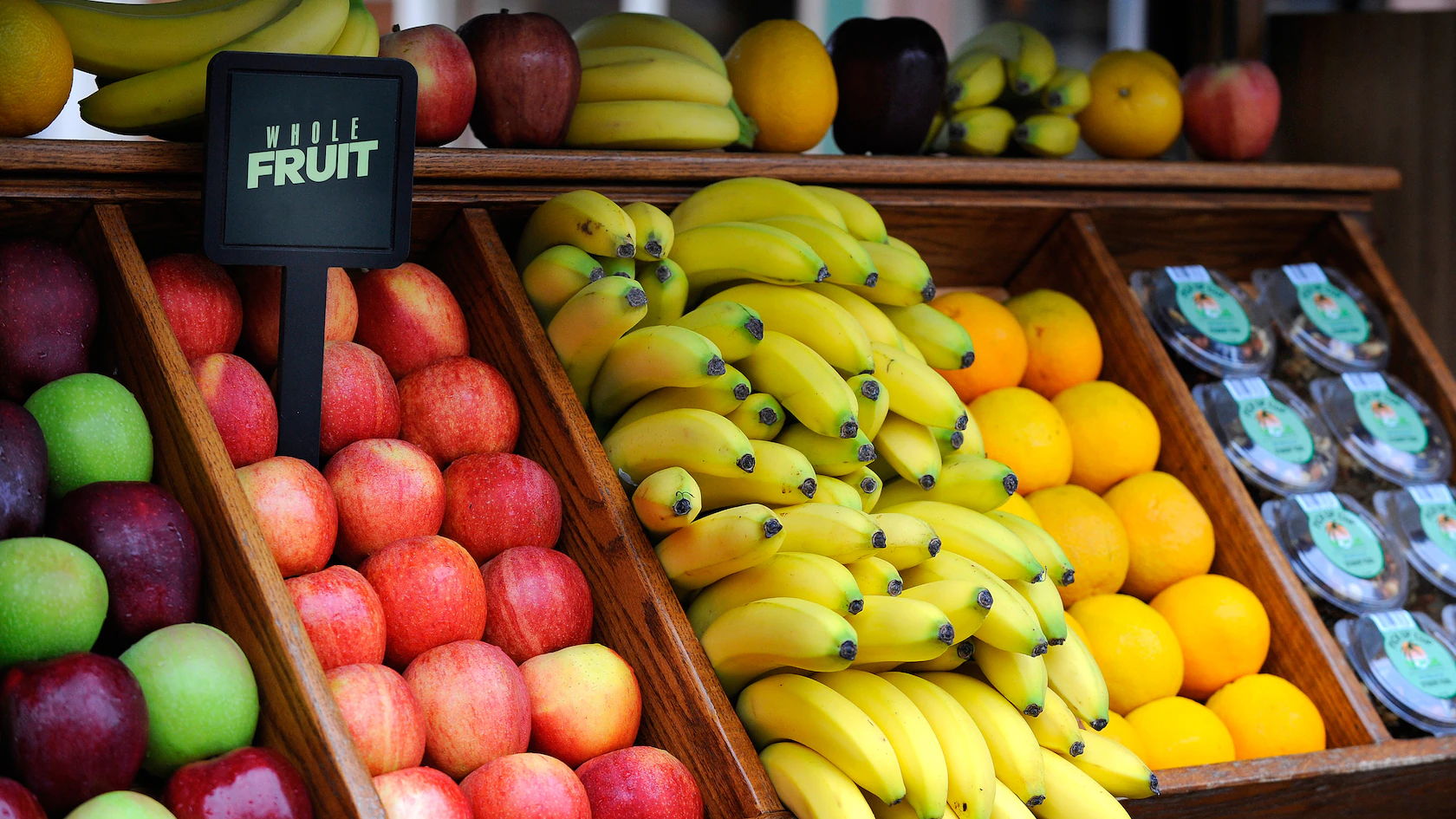 Apples, bananas, and lemons neatly displayed at a Fruit Cart reminiscent of Critter Country.