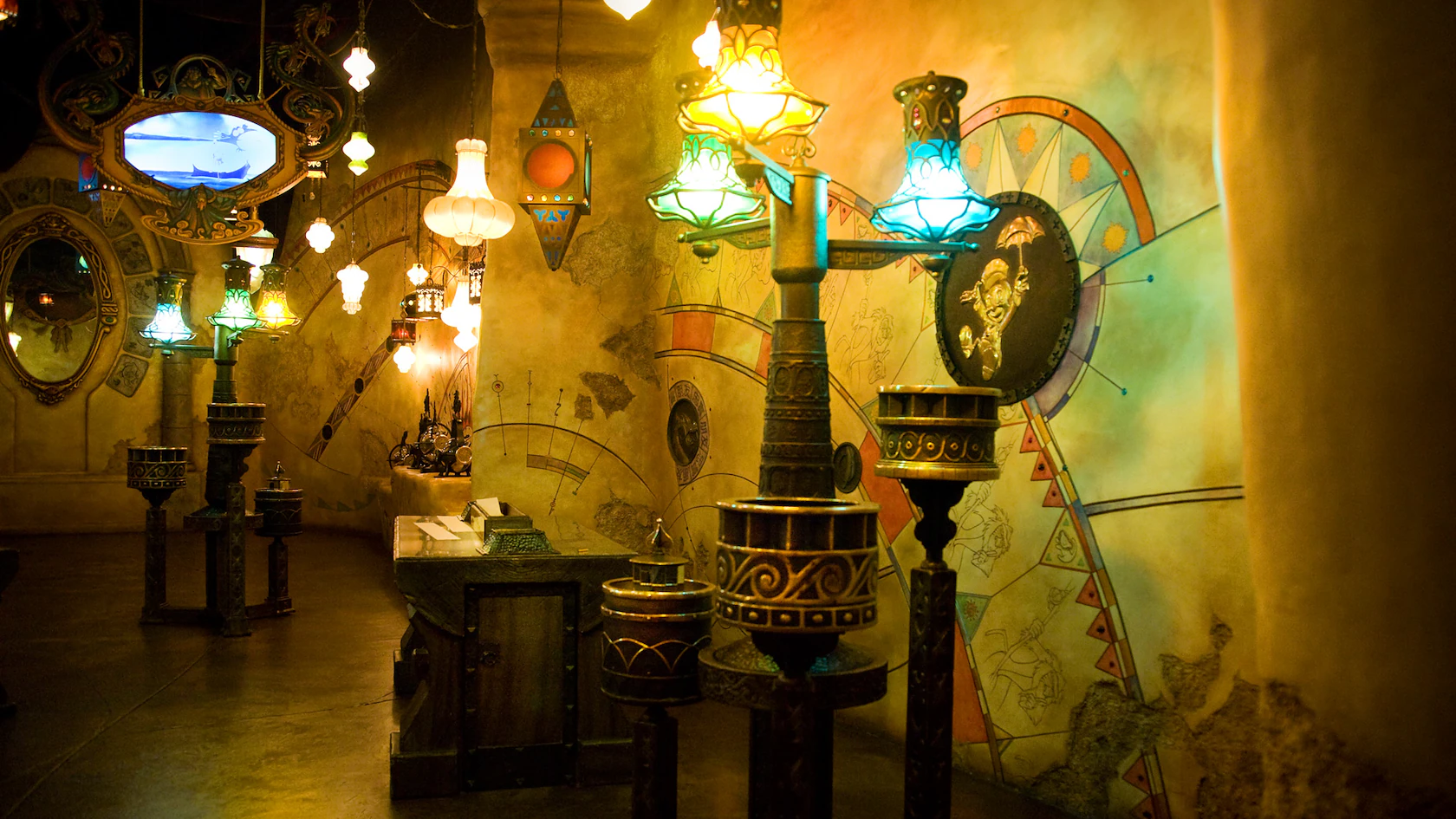 In a dimly lit room reminiscent of a Sorcerer's Workshop, eclectic decor comes alive with ornate lamps boasting colorful glass shades, intricate wall designs, mirrors that reflect mystery, and a small counter for secretive creations.