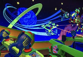 Colorful, futuristic arcade ride with toy blasters like Disney’s Buzz Lightyear Space Ranger Spin, stars, and cartoon aliens.