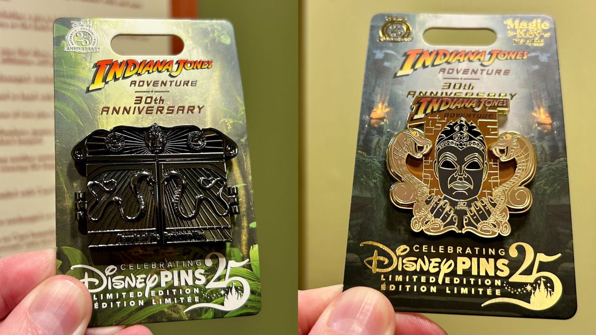 Two hands hold collectible Disney pins on cards, celebrating the 30th anniversary of Indiana Jones Adventure and the impressive legacy of Limited Edition Pins.