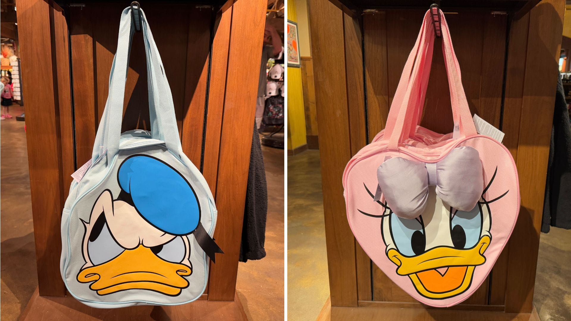Two charming tote bags hang on display, each featuring a duck-themed design. The left bag, reminiscent of Donald Duck with its blue cap and serious expression, pairs perfectly with the right bag's pink bow and long eyelashes, a delightful nod to Daisy Duck.
