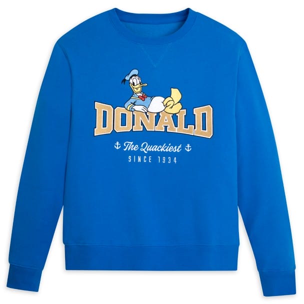 Blue sweatshirt featuring a graphic of a duck in a sailor hat above the word "DONALD" in yellow lettering, with "The Quackiest Since 1934" written below.