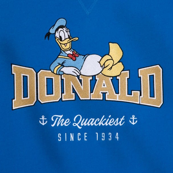 Illustration of Donald Duck lounging above the word "Donald" on a blue background. Text below reads "The Quackiest Since 1934" with two anchor icons.