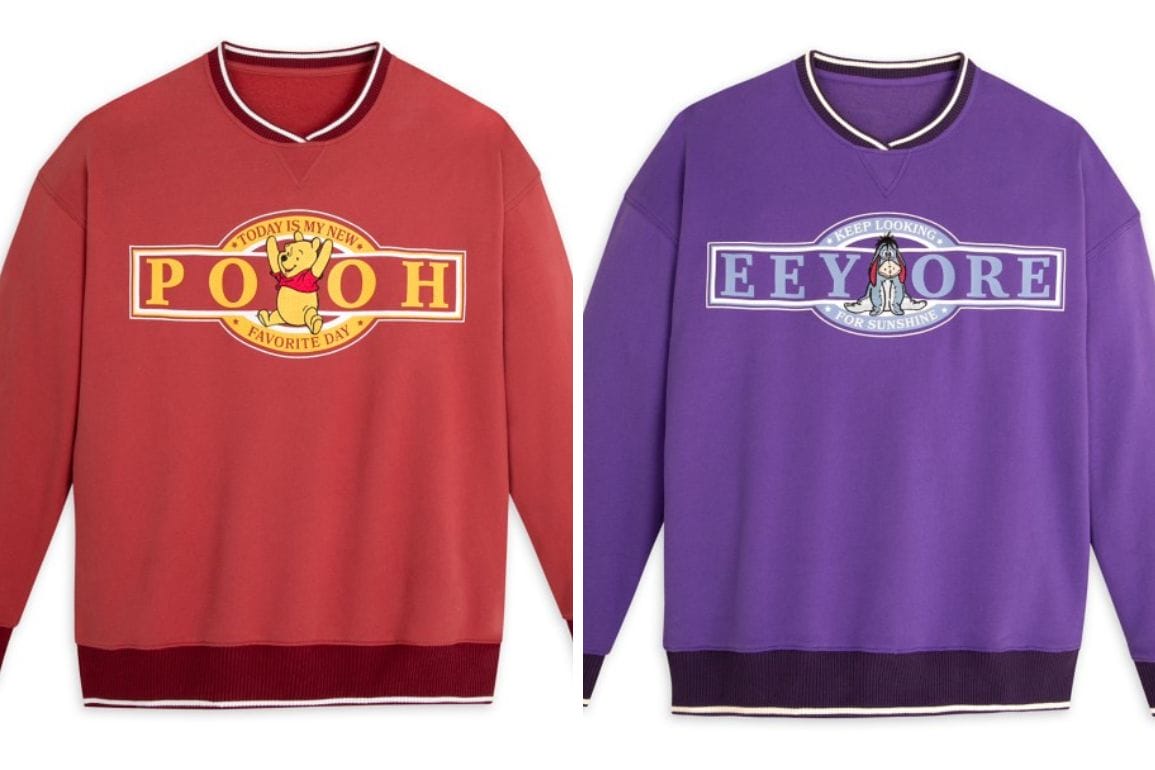 Two sweatshirts: one red with Winnie the Pooh and "Pooh" text, the other purple with Eeyore and "Eeyore" text. Both feature delightful striped collars and cuffs, perfect for any fan of the beloved Winnie the Pooh series.