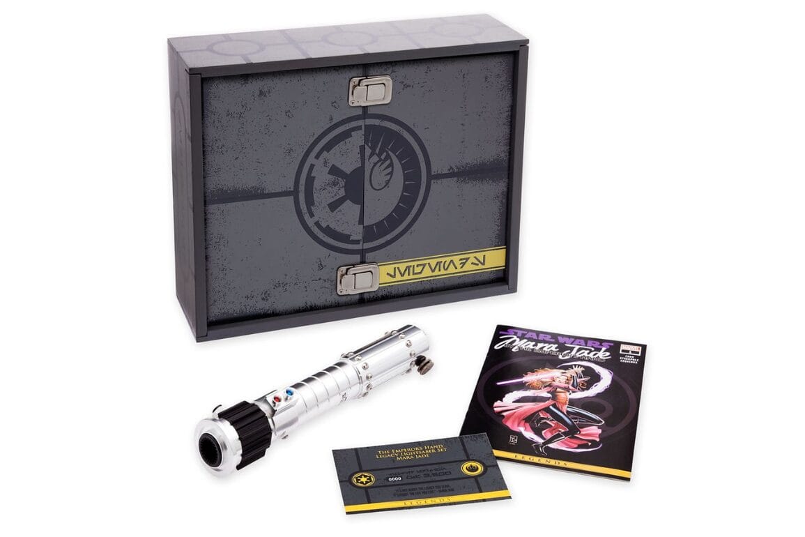 A Star Wars collectible set featuring a silver Mara Jade lightsaber hilt, a certificate, a comic book, and a decorative box with an Imperial emblem.