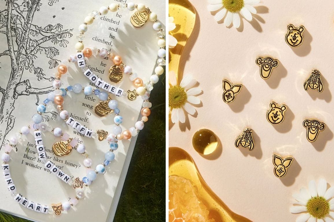 Beaded bracelets and gold pins with animal faces from the Little Words Project rest on a book and a honeycomb-patterned surface adorned with daisies.