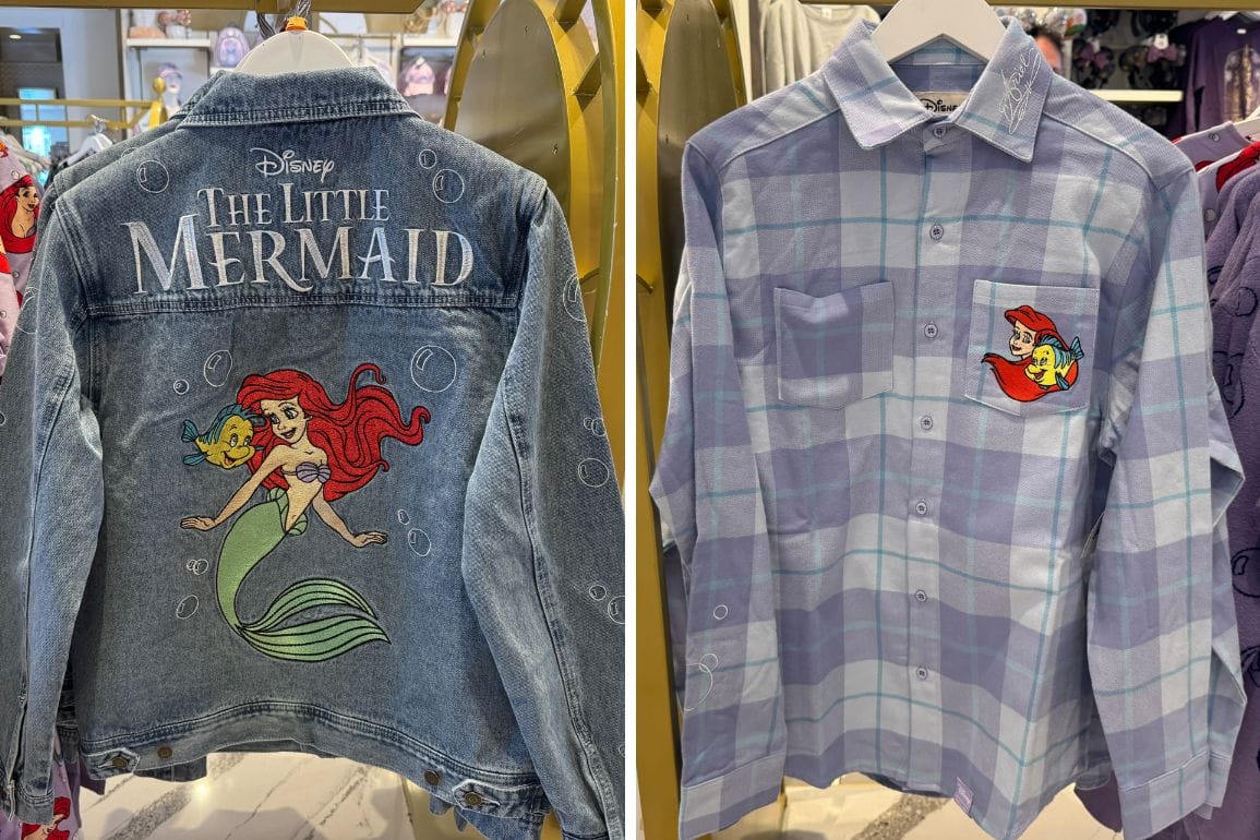 Displayed on hangers, this denim jacket showcases a striking "The Little Mermaid" design on the back, while the plaid shirt features a charming Ariel and Flounder graphic tucked neatly on the chest pocket.