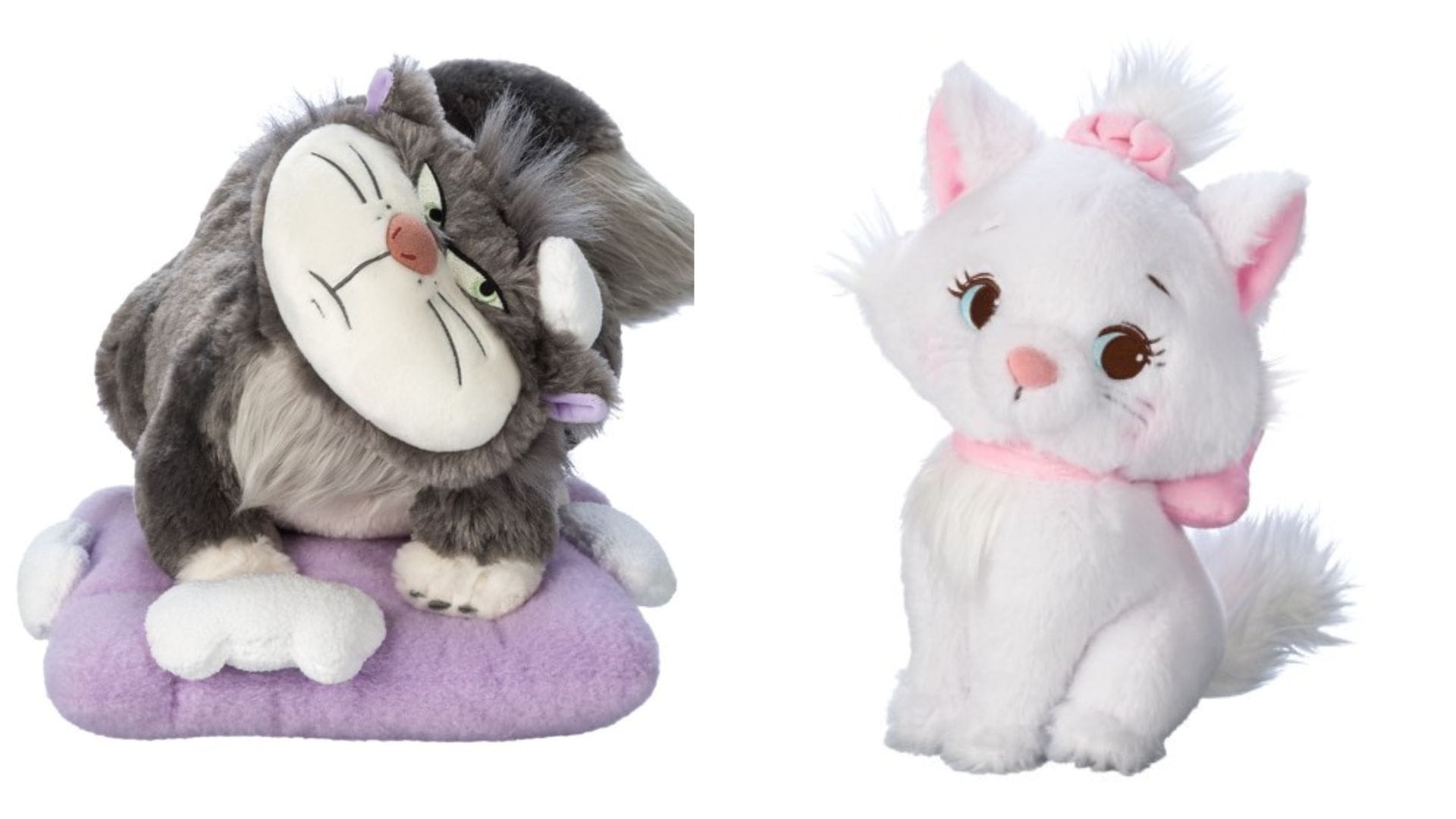 Two plush toys from the Disney Cats Plush collection: a grumpy gray cat on a purple cushion, and a white cat with a pink bow and scarf, sitting upright.