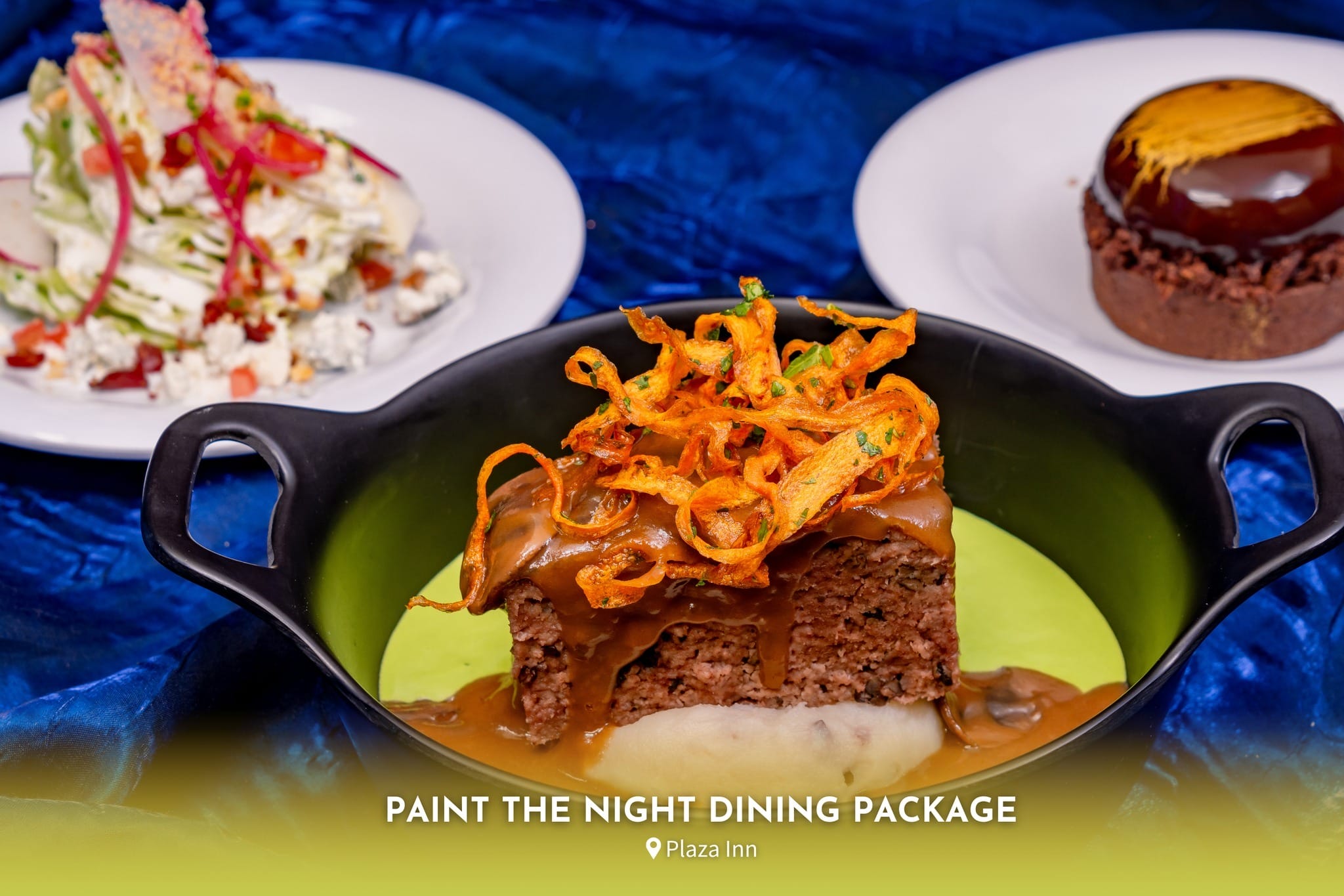 A plated meal with meatloaf topped with crispy onions, mashed potatoes, and desserts on the side, labeled "Paint the Night Dining Package at Plaza Inn.
