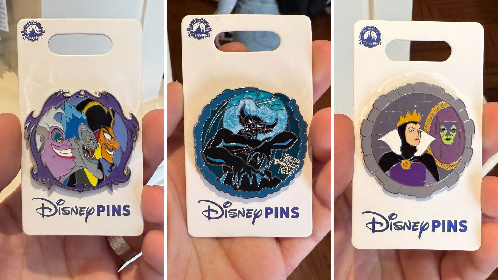 Three captivating Disney villains pins are showcased on card holders, featuring Ursula alongside Jafar, the menacing Chernabog, and the Evil Queen with her Mirror.