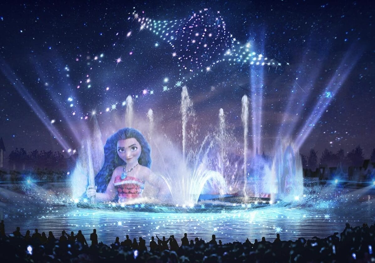 An illuminated water and light show at Disney Adventure World features a large projection of an animated girl with long hair. Above, a starry manta ray design graces the sky in this stunning nighttime spectacle.