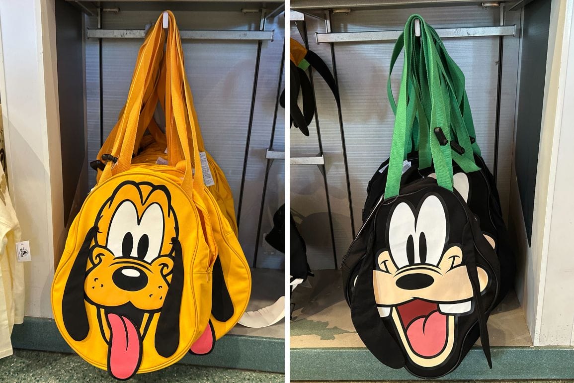 Two cartoon-themed tote bags hang side by side. The left bag, yellow with Pluto's face, contrasts the right one in black and green featuring Goofy's face. Each boasts long straps for easy carrying.