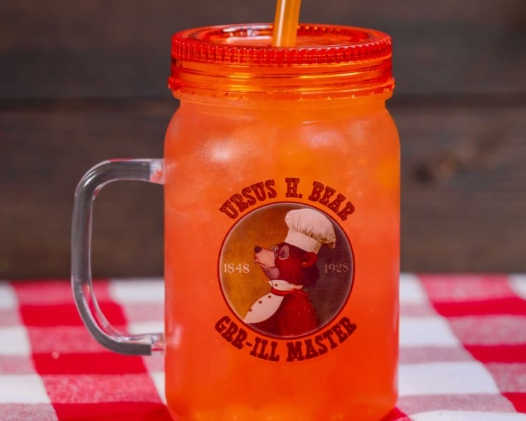 An orange mason jar sipper with ice, a straw, and a bear chef logo reading “Ursus H. Bear Grr-ill Master.”