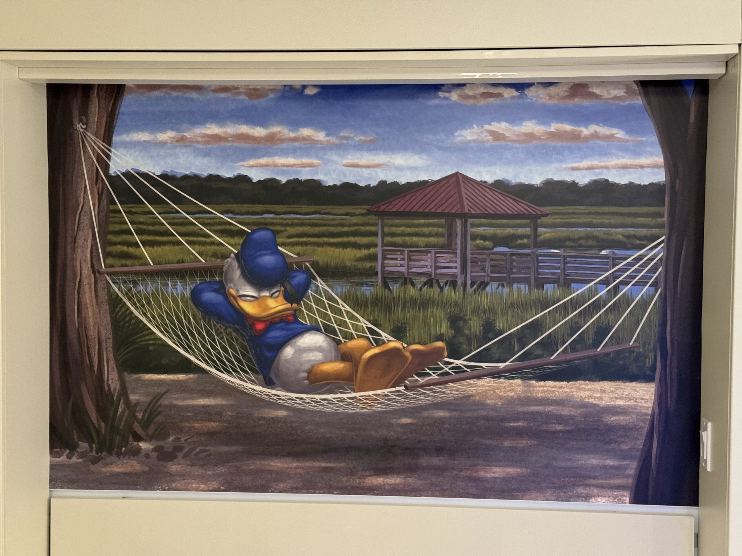 Donald Duck is lounging on a hammock between two trees, soaking in the picturesque view of a wooden pier and pavilion over the water at Disney's Hilton Head Island Resort. It's the perfect spot to unwind after touring the newly remodeled 1-bedroom villas nearby.