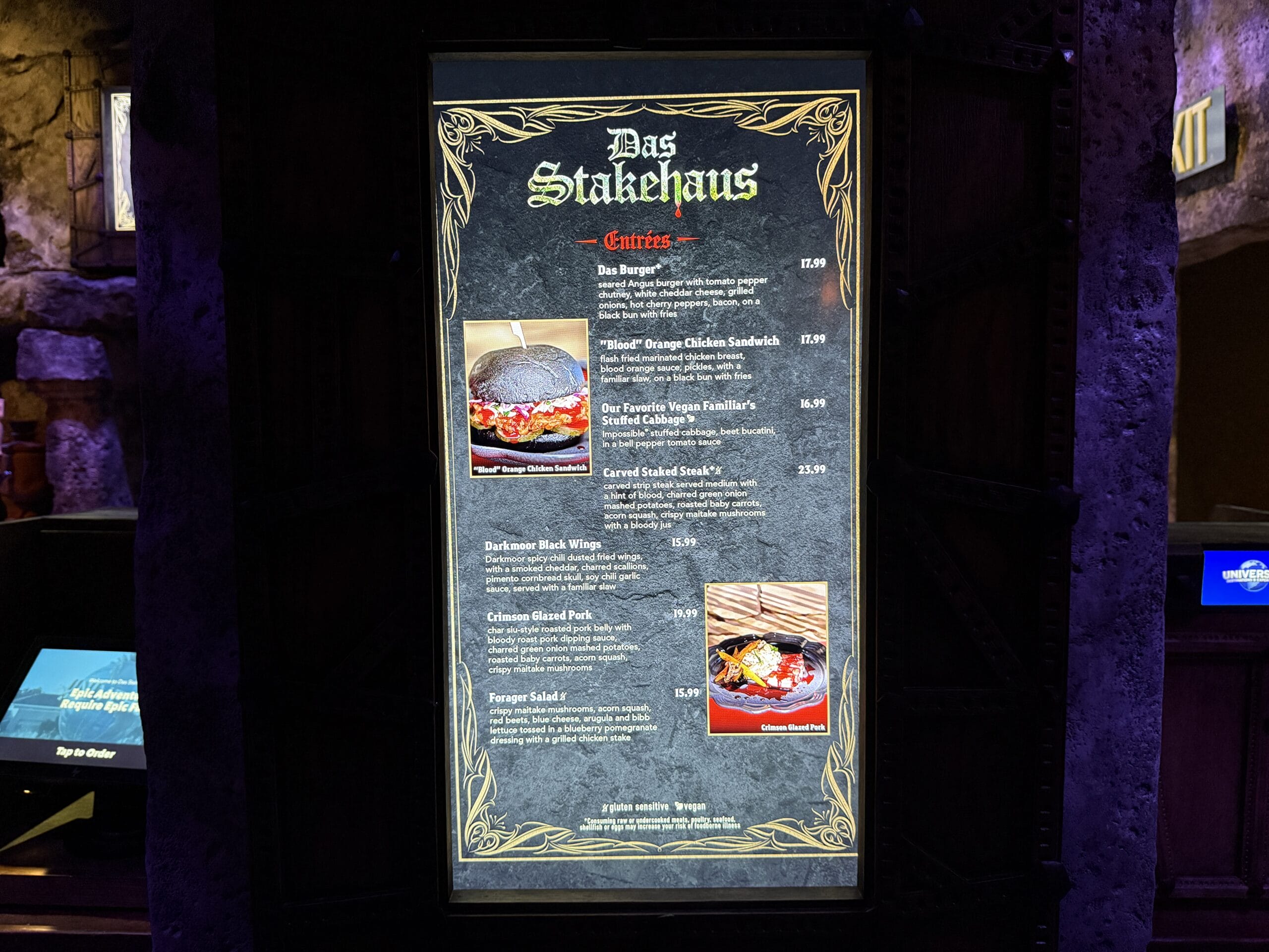 Das Stakehaus menu board displays entree options with dish images in a dark, themed Das Stakehaus setting.
