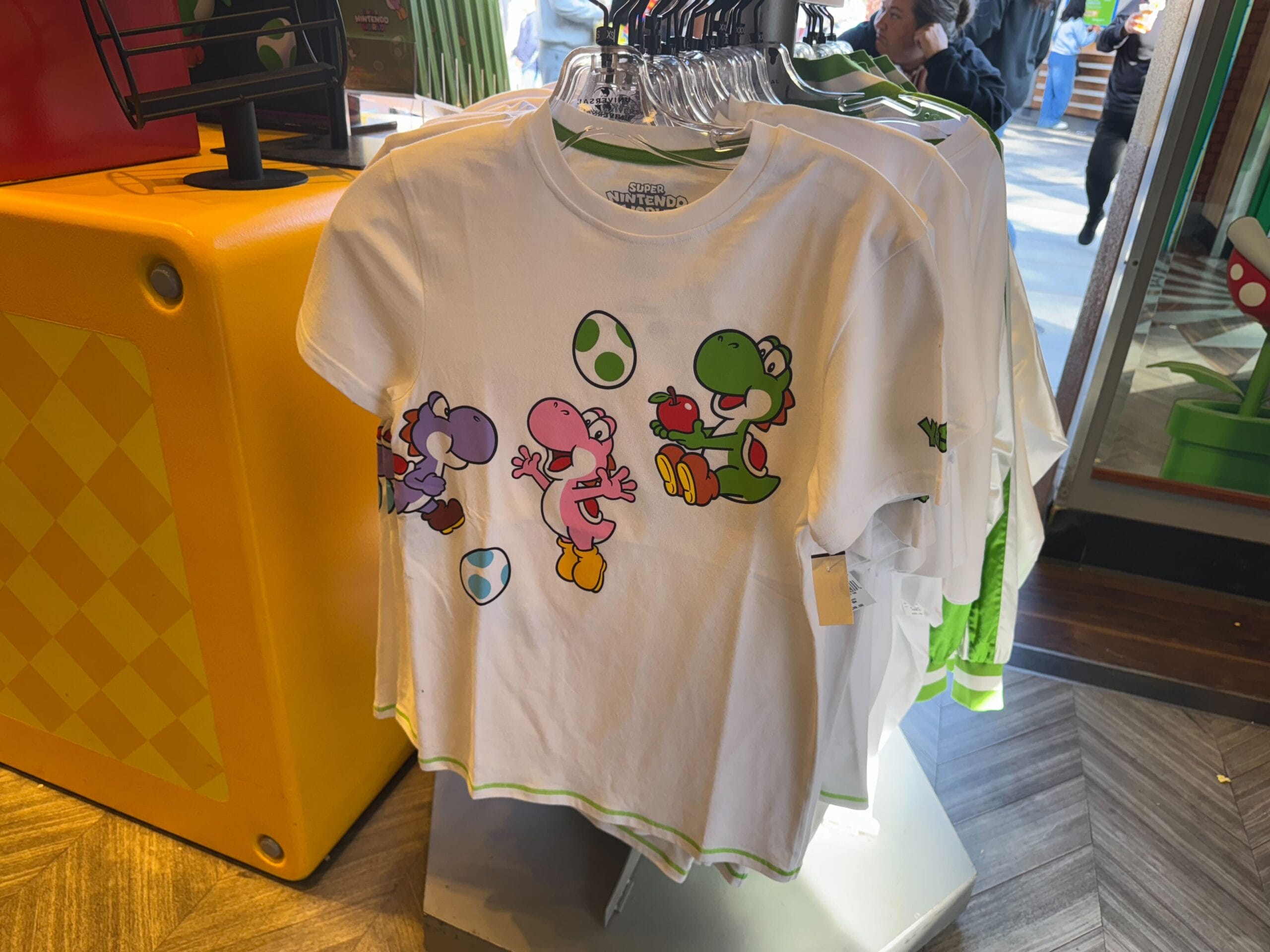 White T-shirt with colorful Yoshis and Yoshi eggs, perfect Yoshi merchandise at Universal Studios Hollywood.