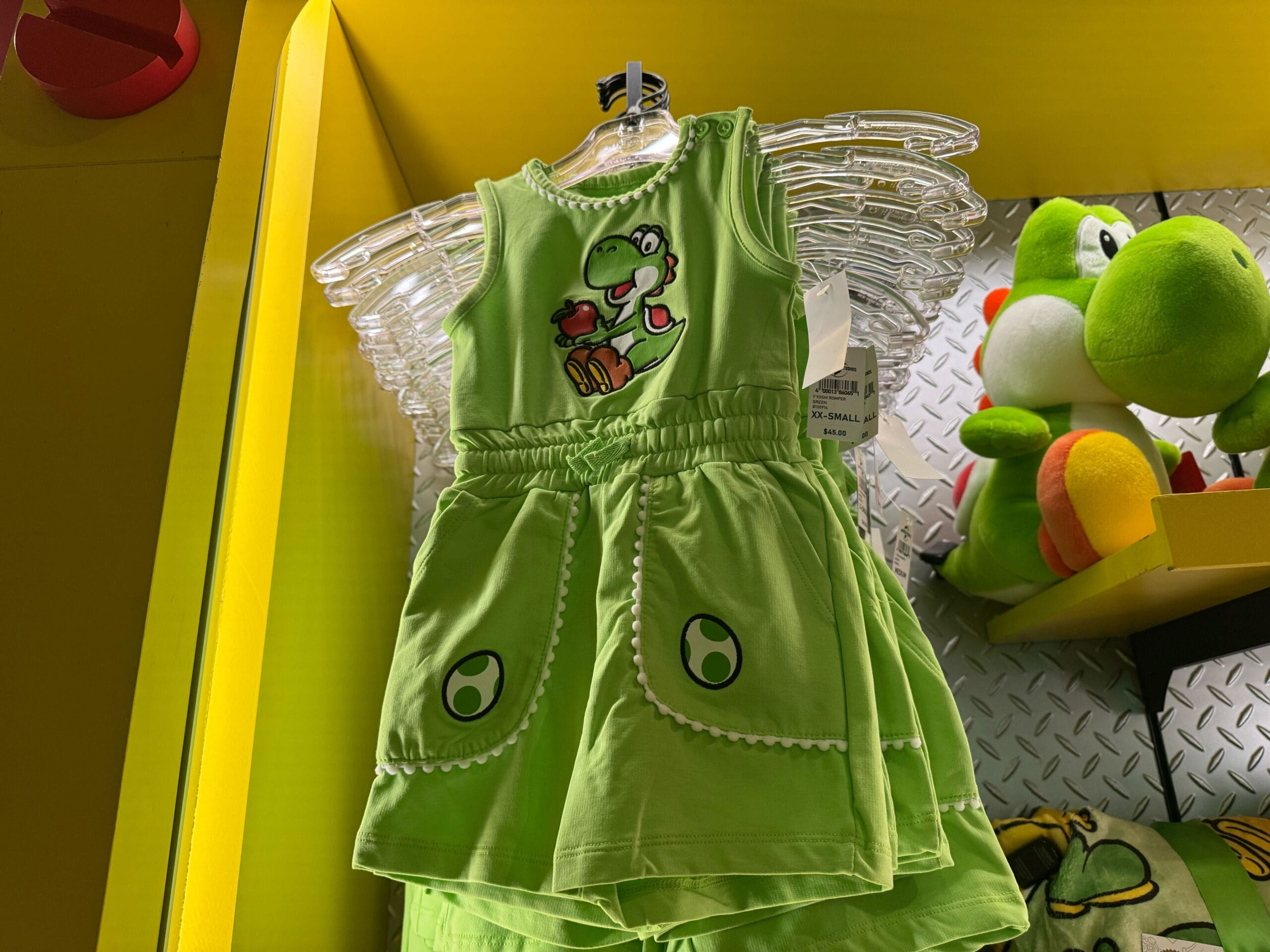 Green toddler dress with Yoshi design and egg pockets, perfect Yoshi merchandise for Universal Studios Hollywood fans.