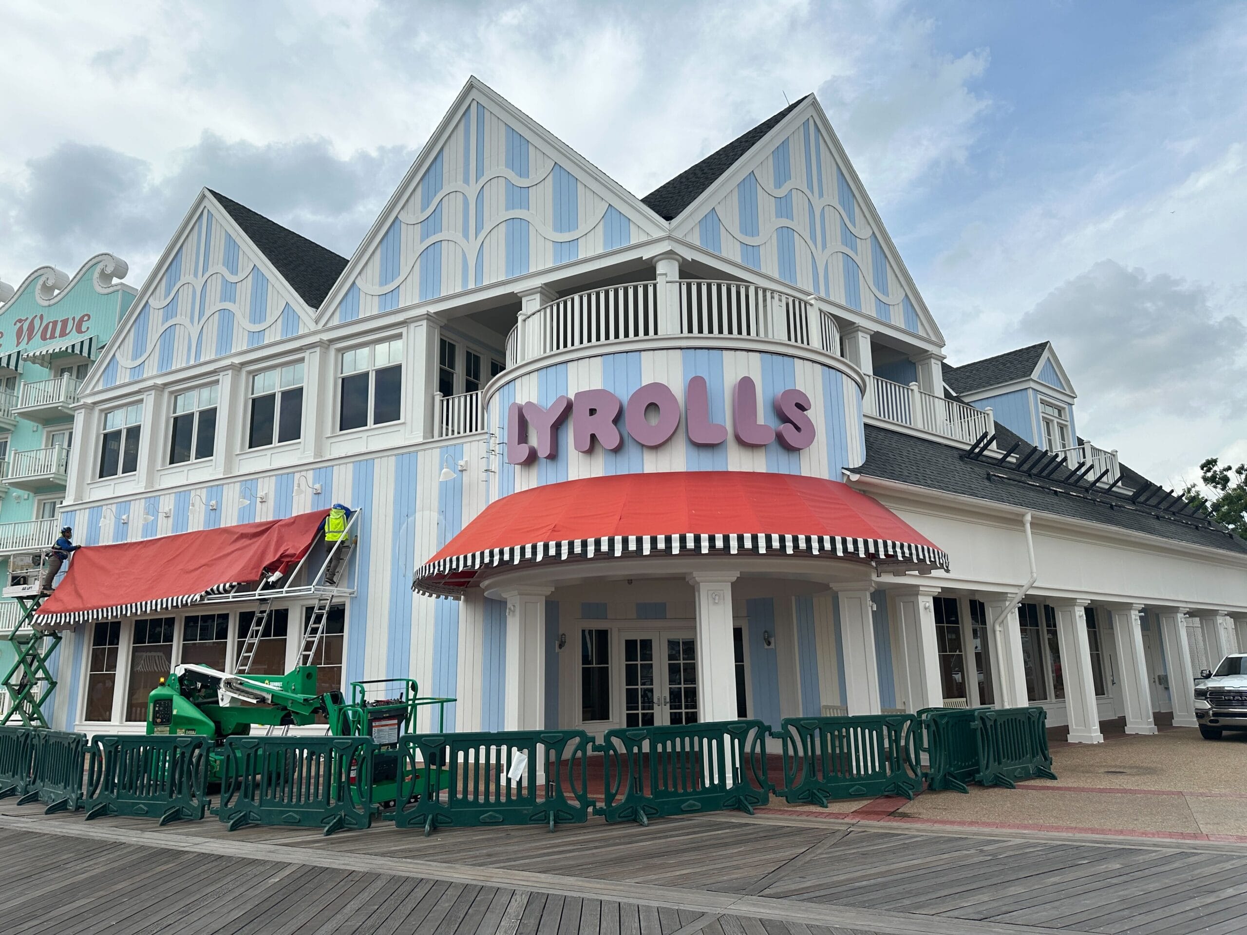 A pastel blue and white striped building with Jellyrolls Awnings and bold "PYROLLS" signage above the entrance.