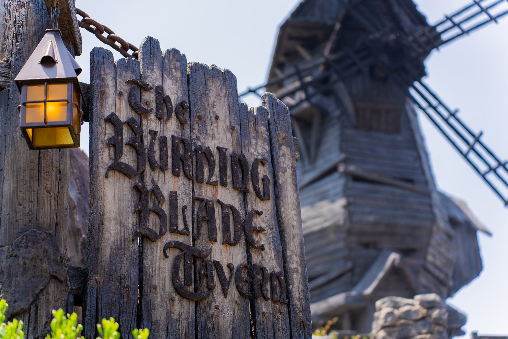 A weathered wooden sign reads "The Burning Blade Tavern"—a must-see on your First Visit Epic Universe adventure.