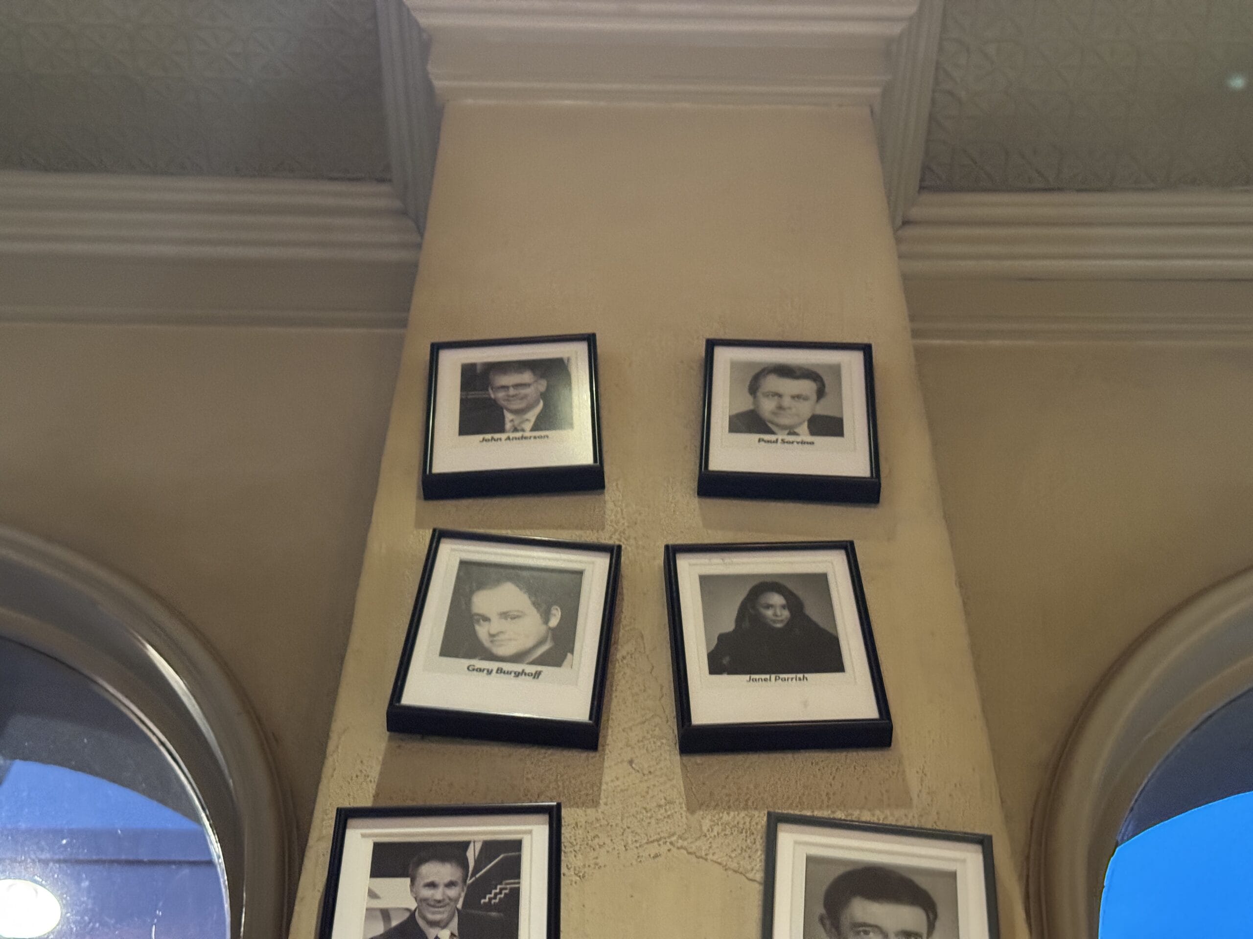 Five black-and-white photos are displayed vertically on a beige column at Mama Melrose’s Ristorante Italiano.