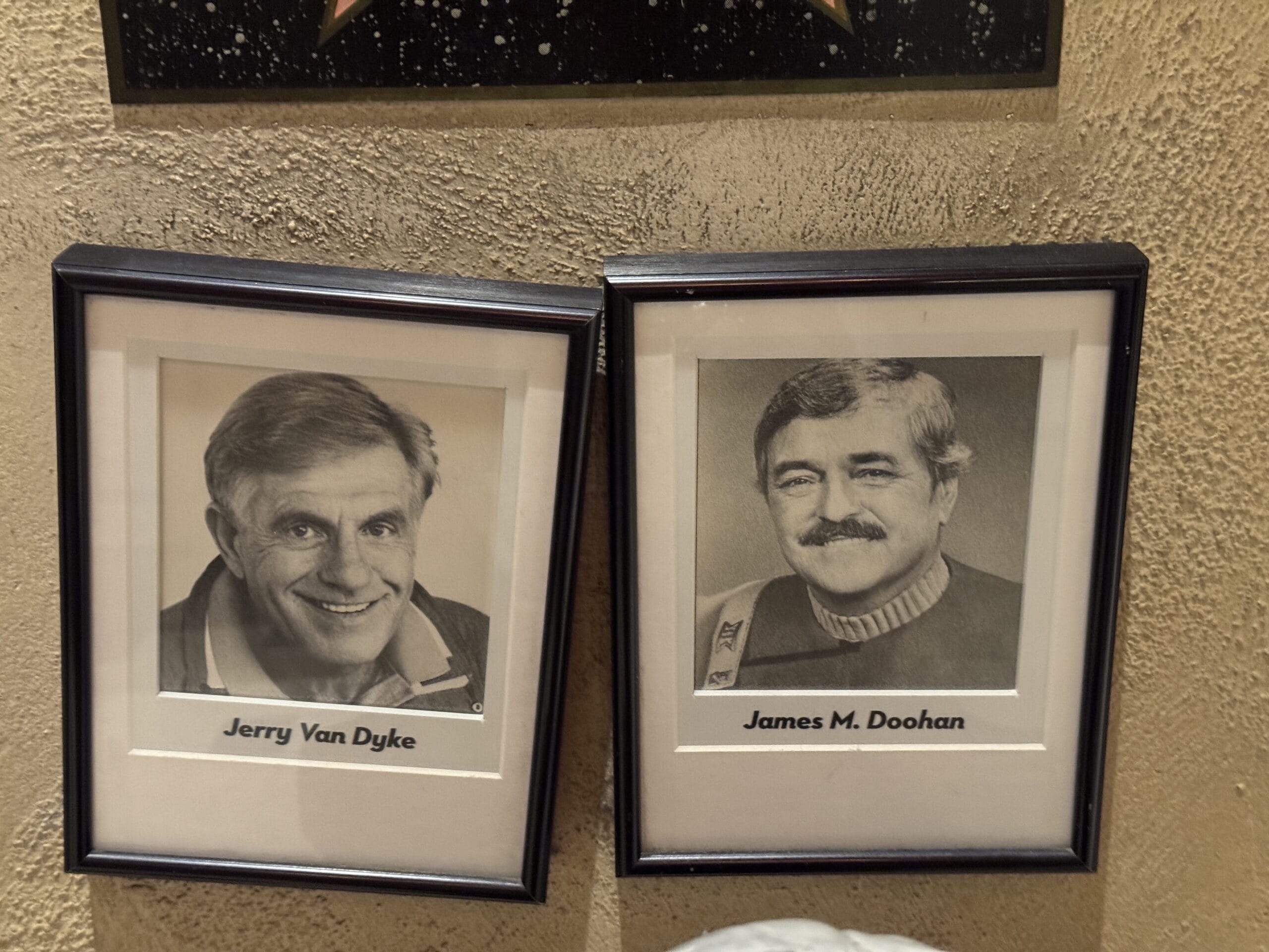 Two framed black-and-white photos at Mama Melrose’s Ristorante Italiano hang on a textured beige wall.