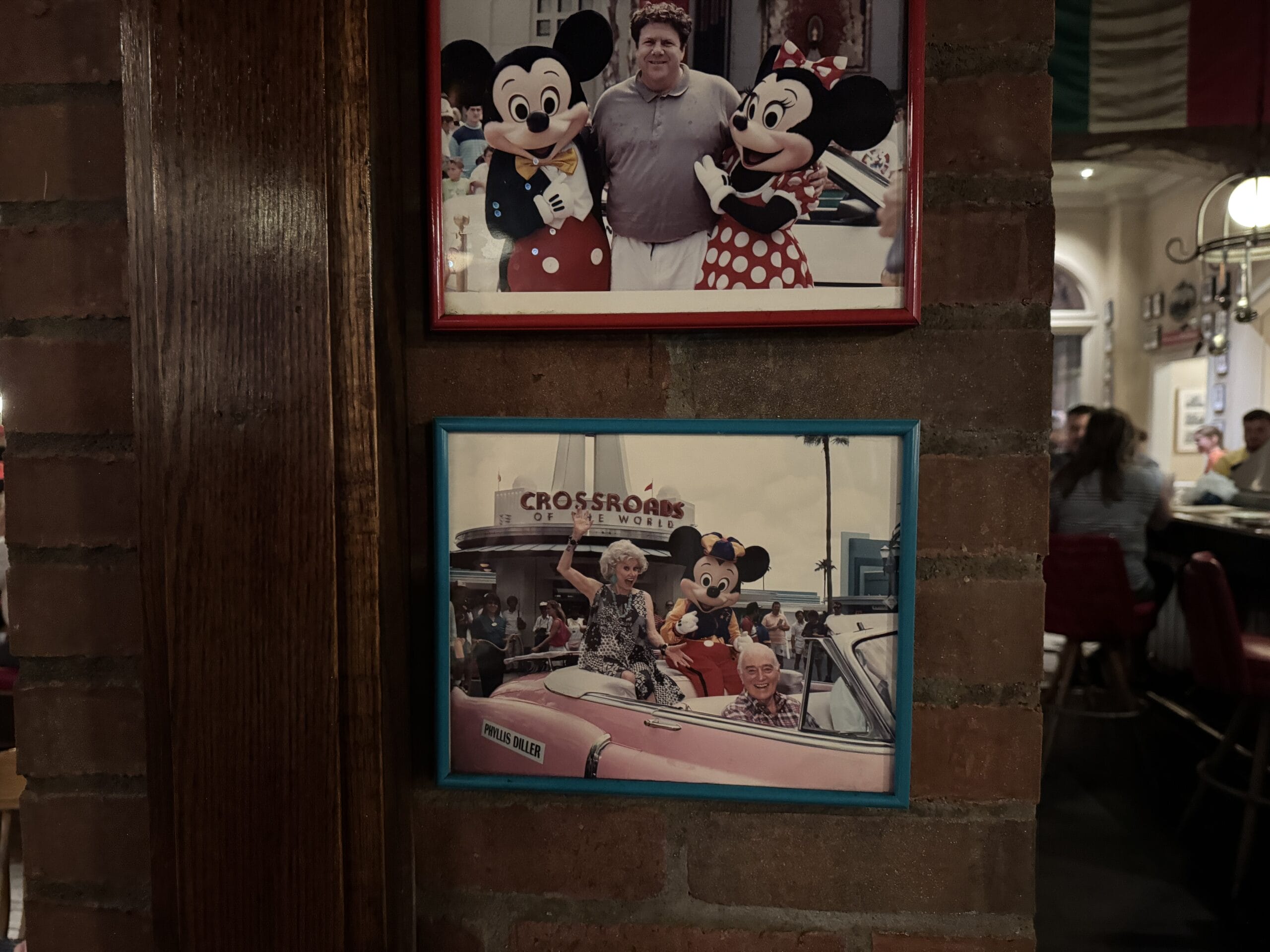 Two framed photos at Disney's Hollywood Studios: a man with Mickey mascots, and seniors in a pink car with Minnie.