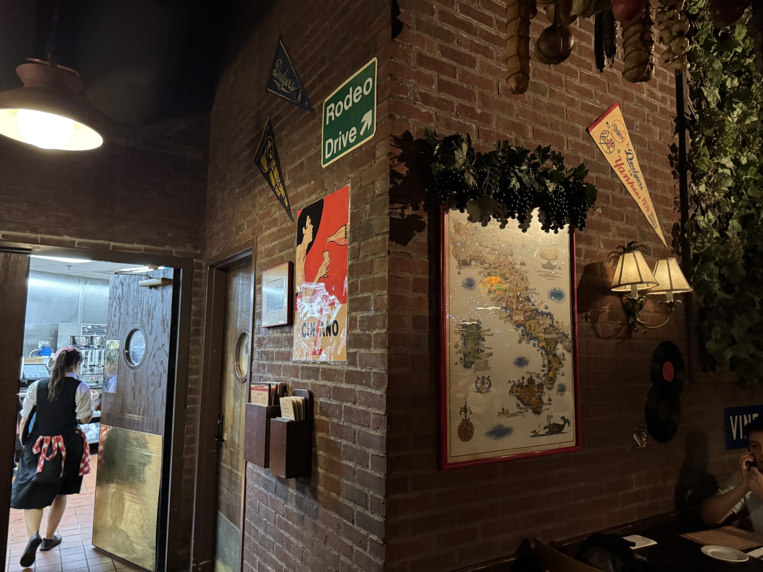 A dimly lit restaurant with brick walls and vintage decor, like Mama Melrose’s Ristorante Italiano at Disney's Hollywood Studios.