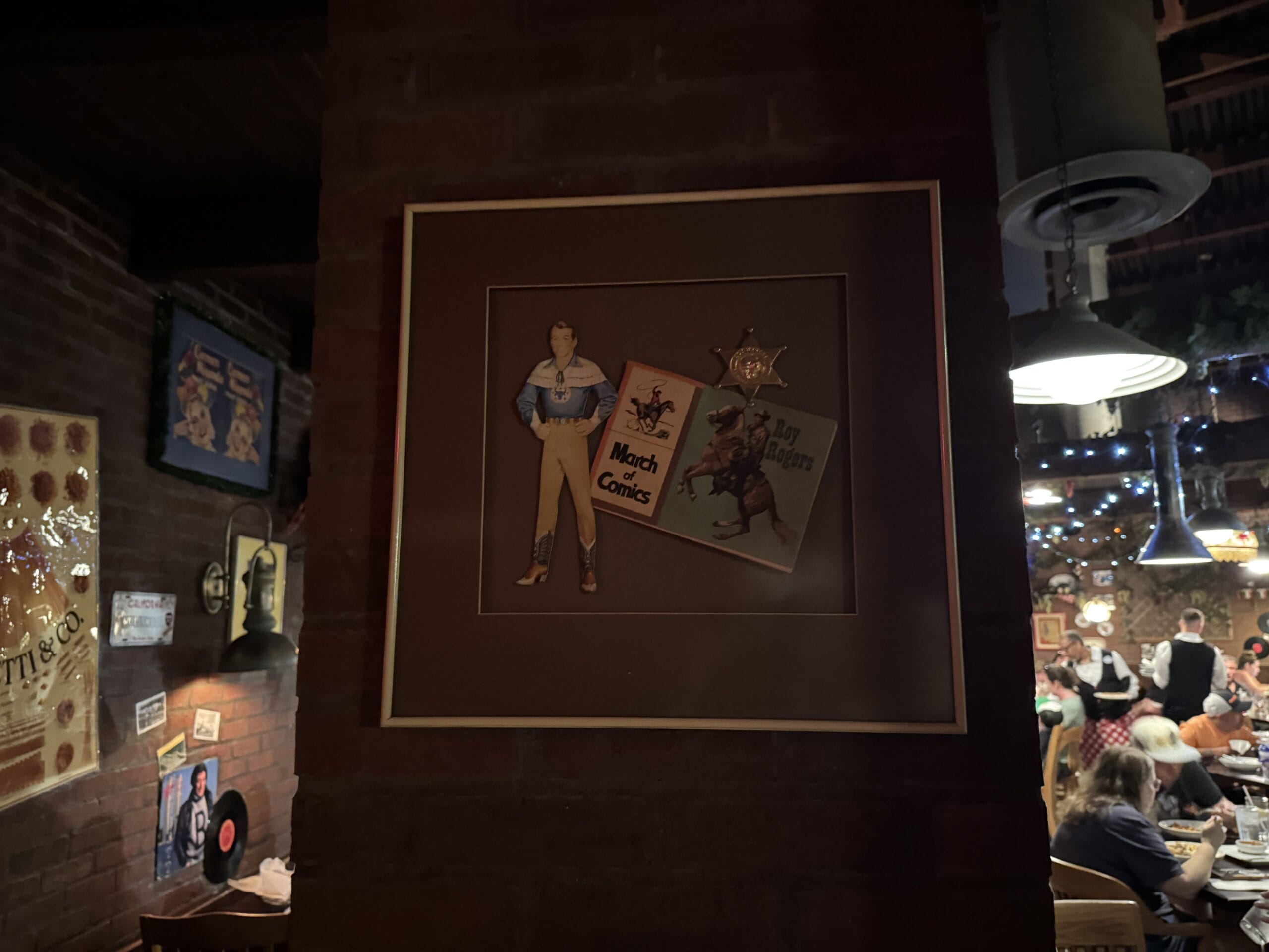 Framed comic-themed artwork and photos at Mama Melrose’s Ristorante Italiano in Disney's Hollywood Studios.
