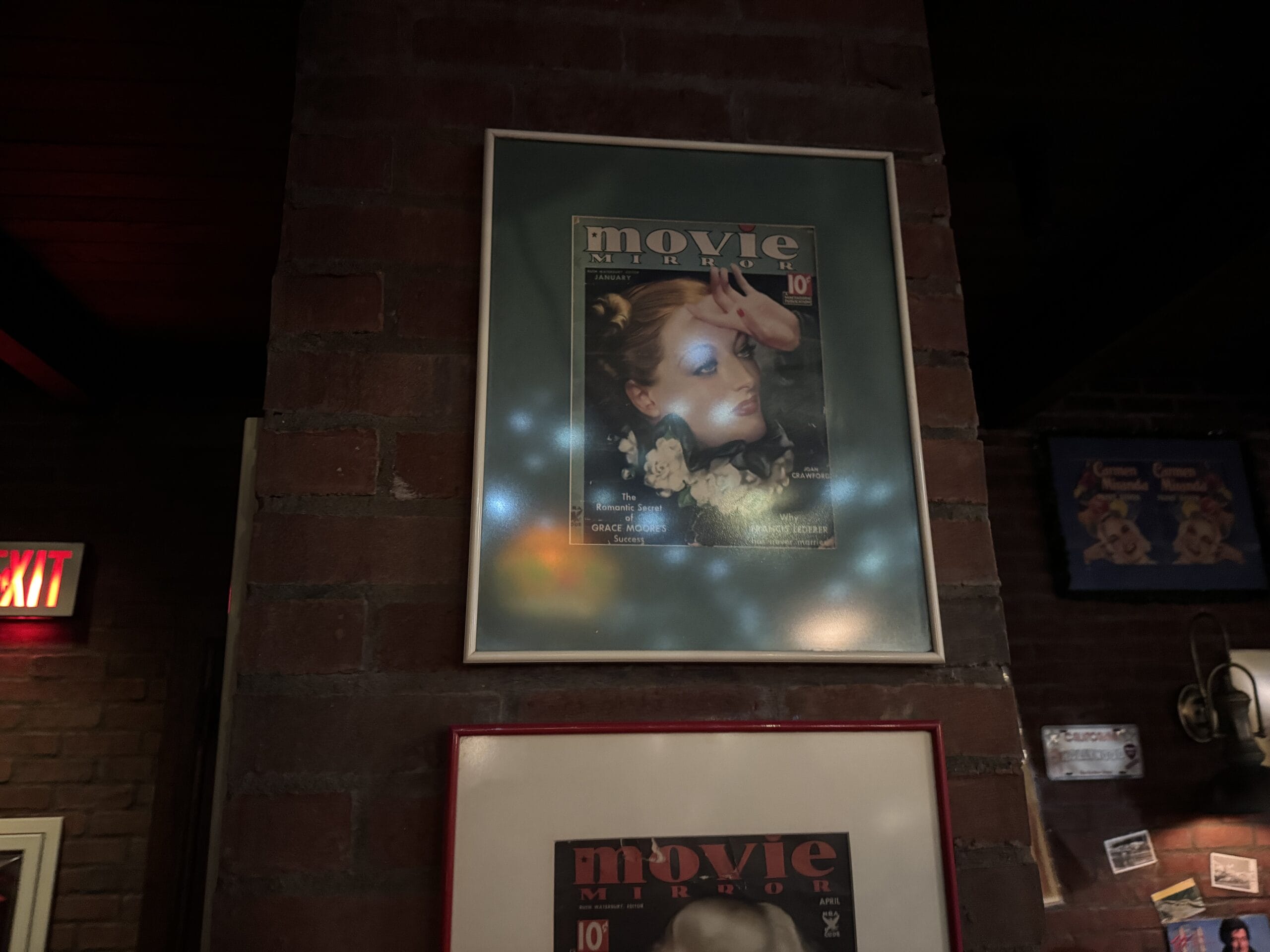Framed vintage "Movie Mirror" magazine cover at Mama Melrose’s Ristorante Italiano, Disney's Hollywood Studios, with light glare.