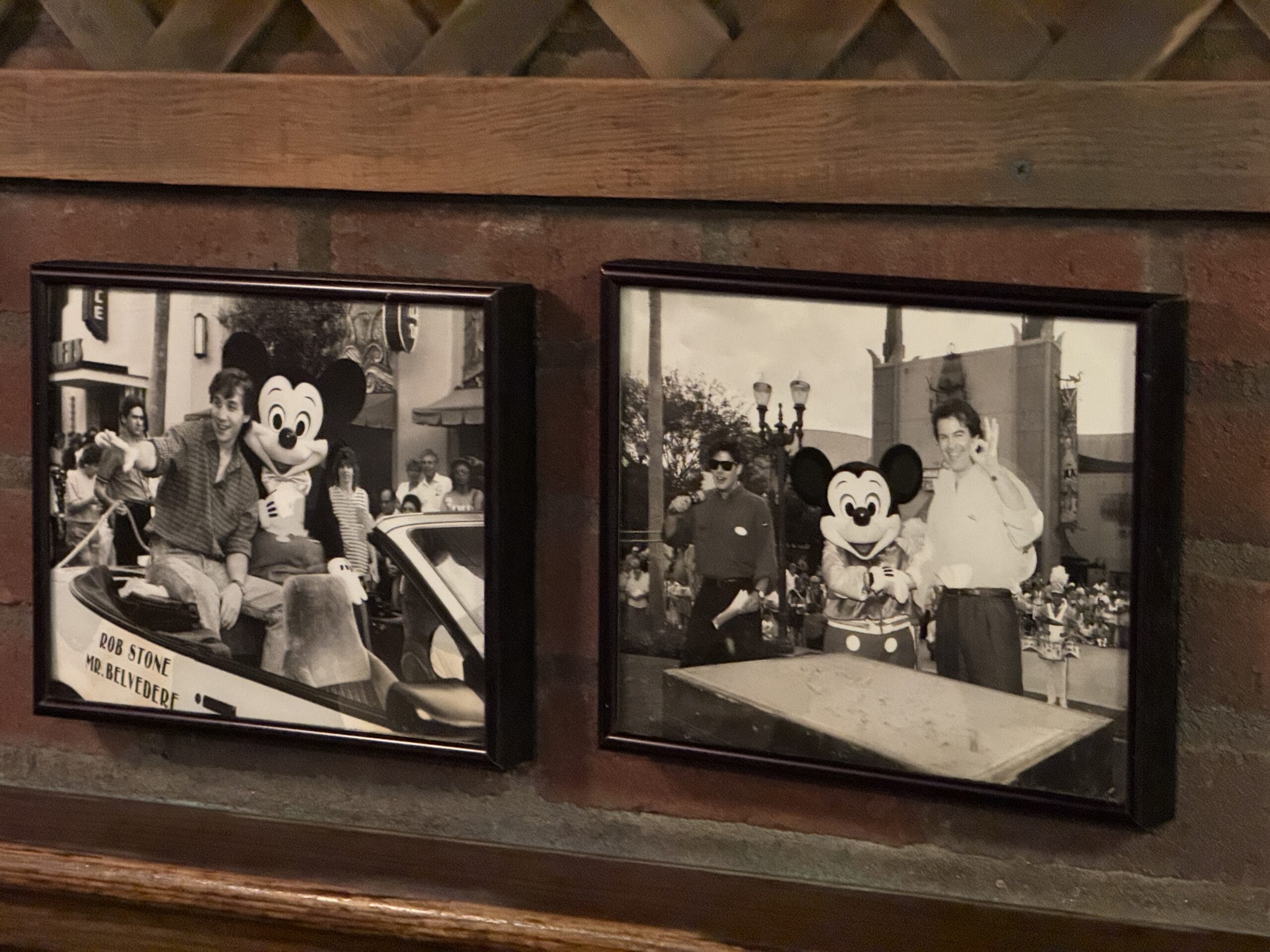 Two framed black-and-white photos of people with Mickey Mouse, perfect for fans of Disney's Hollywood Studios.
