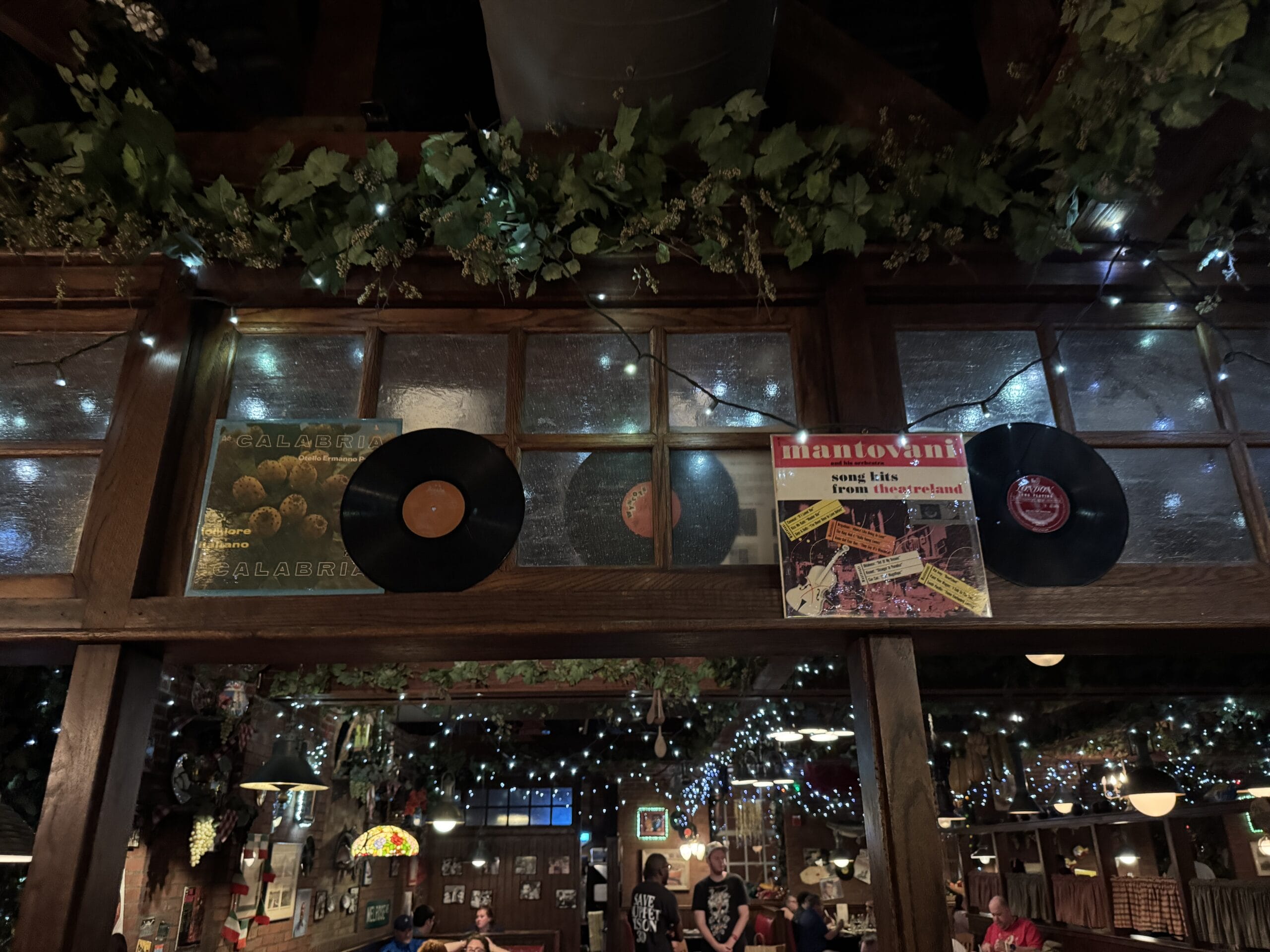 Vinyl records and a Mantovani album hang on a wooden wall at Mama Melrose’s Ristorante Italiano in Disney's Hollywood Studios.