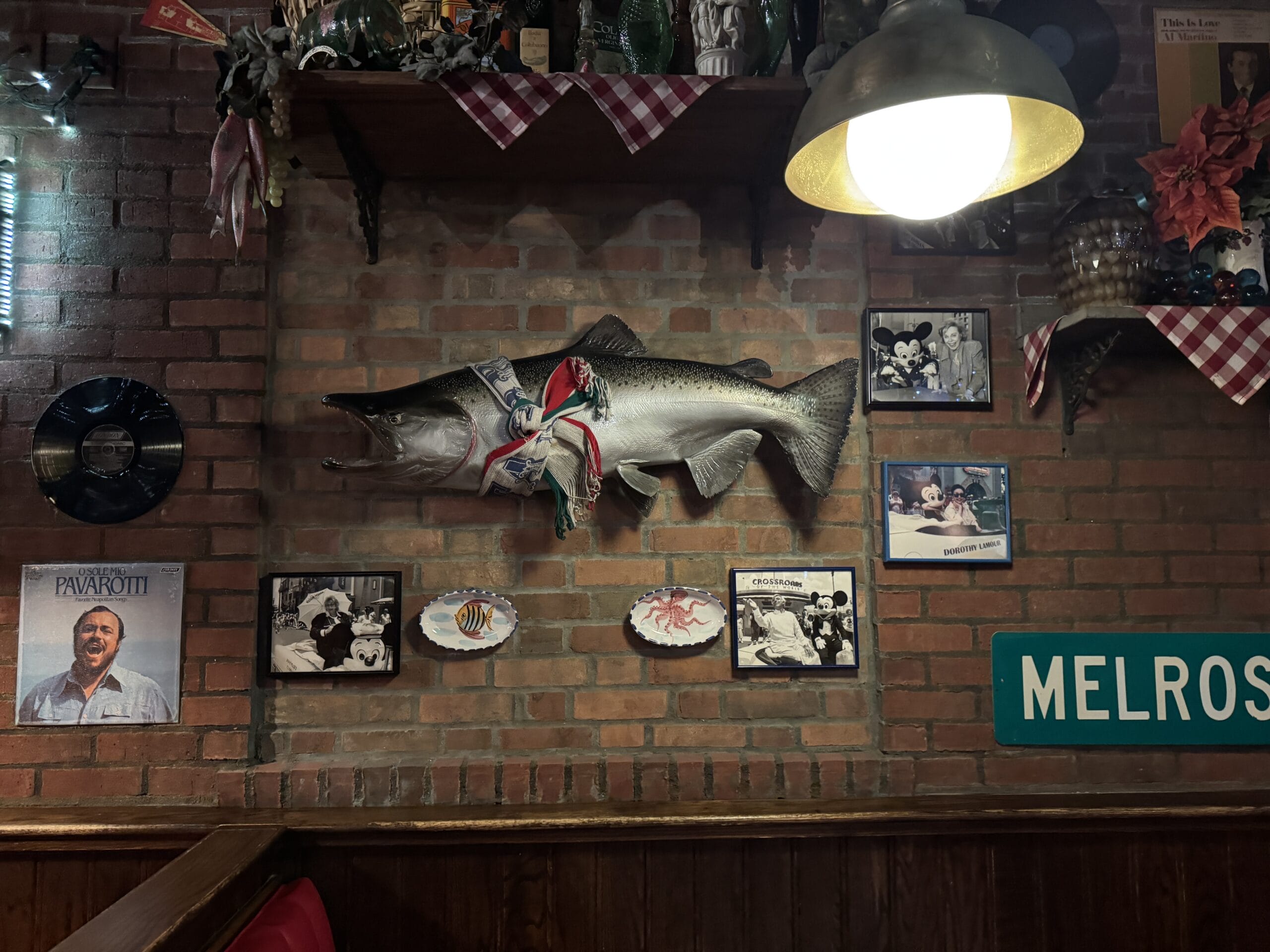 A mounted fish and vintage photos hang in Mama Melrose’s Ristorante Italiano at Disney's Hollywood Studios.