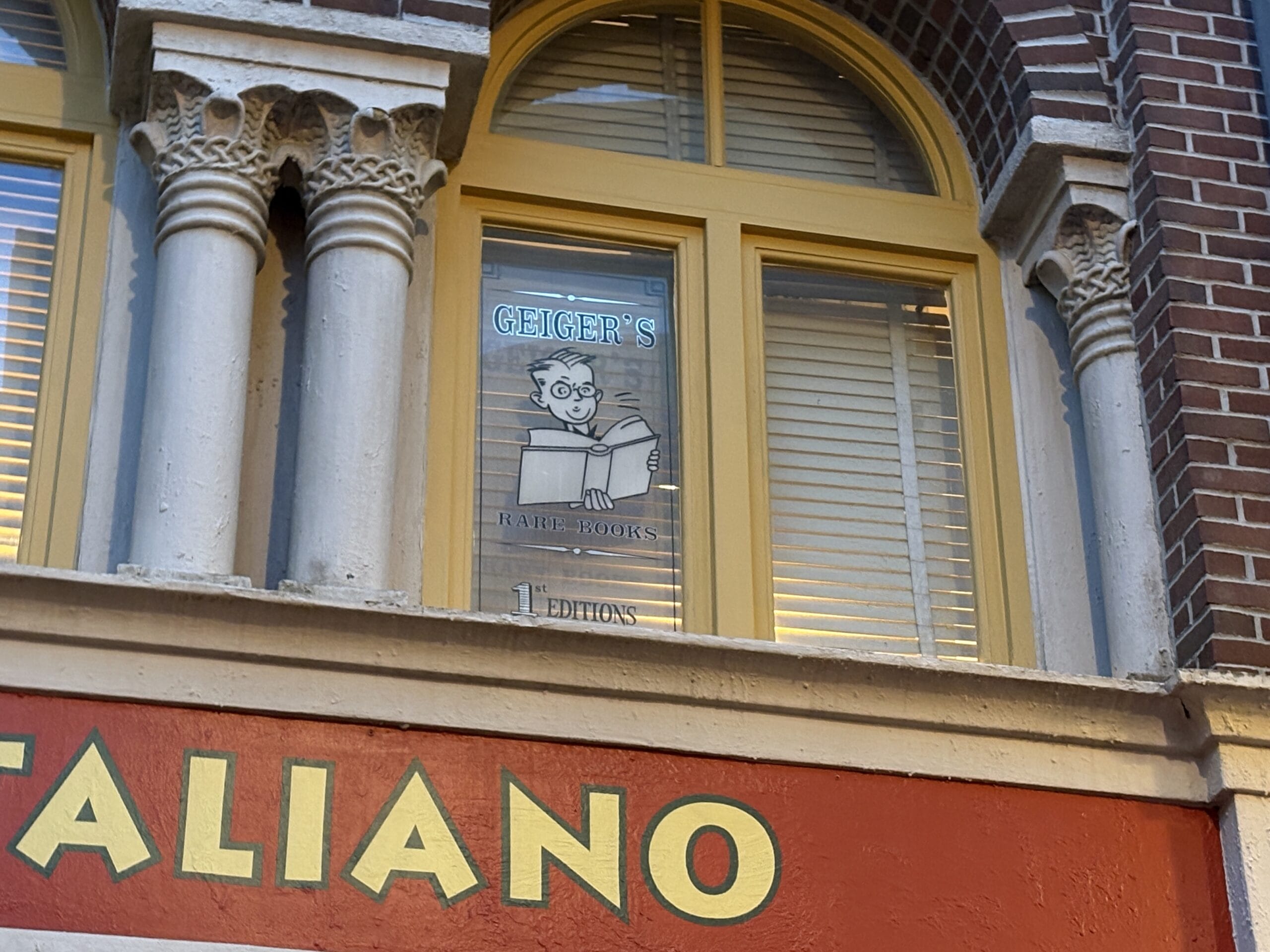 A window sign reads "Geiger's Rare Books 1st Editions" above Mama Melrose’s Ristorante Italiano at Disney's Hollywood Studios.