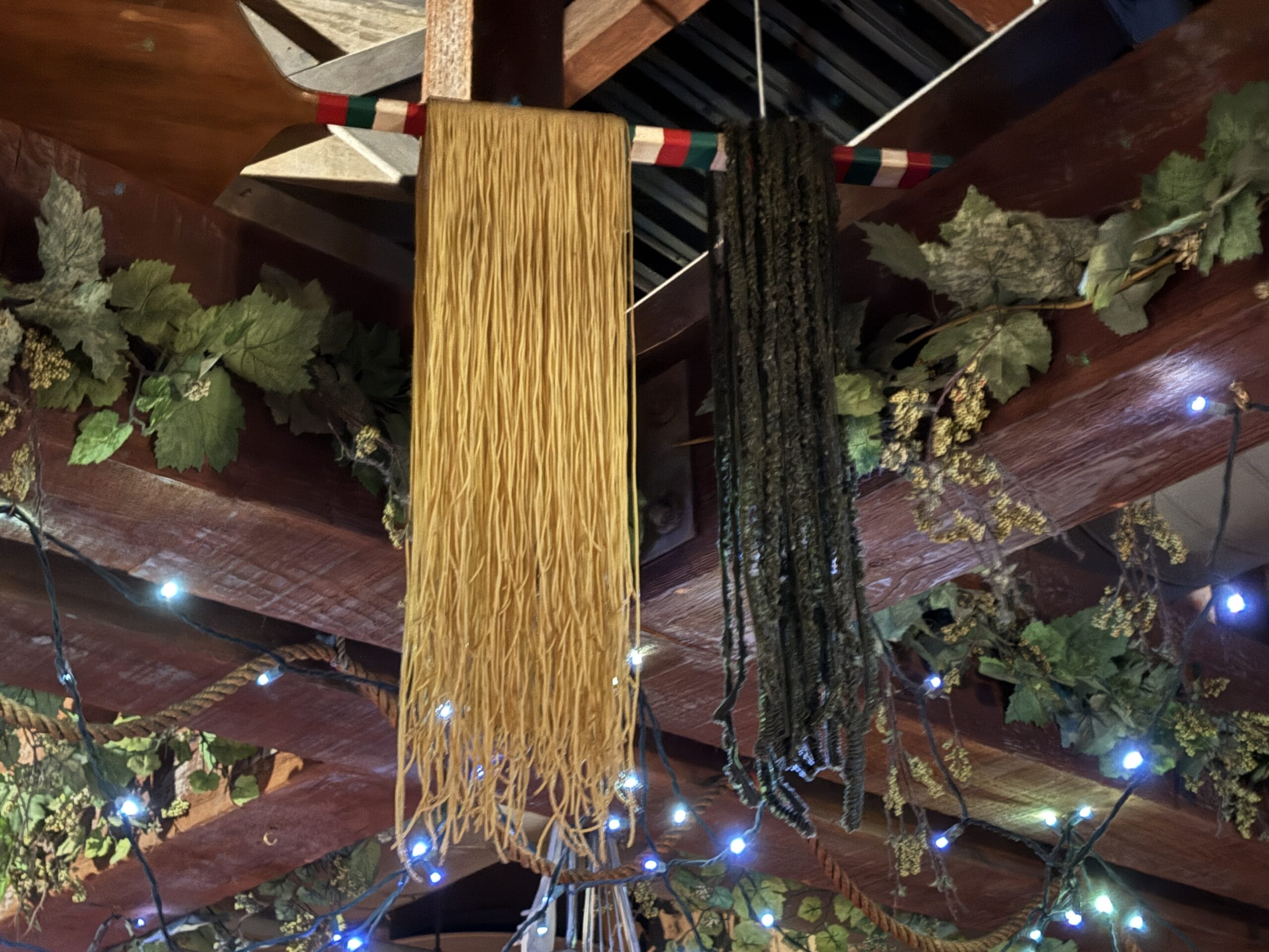Two types of pasta hang from a vine-wrapped beam at Mama Melrose’s Ristorante Italiano in Disney's Hollywood Studios.