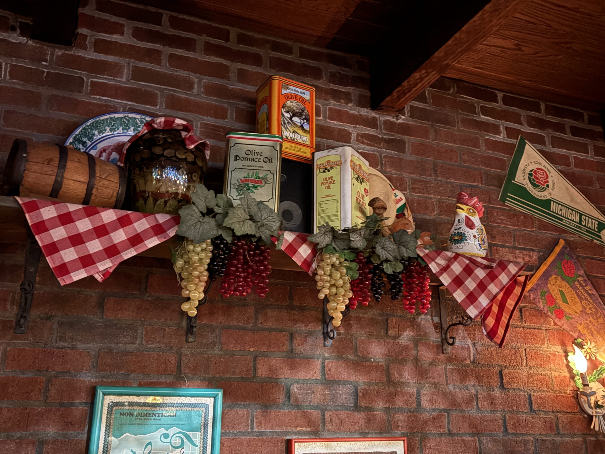 A shelf at Mama Melrose’s Ristorante Italiano displays fake grapes, vintage tins, and plates—perfect for photos.