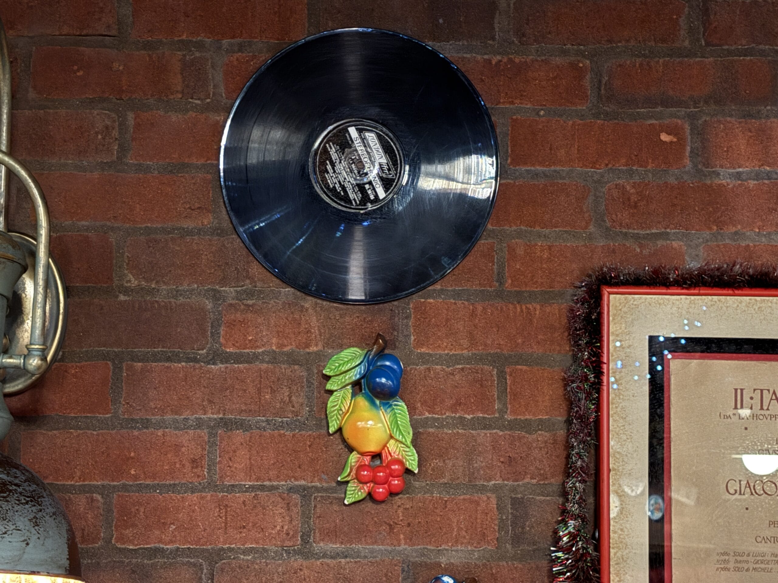 A vinyl record and fruit wall art at Mama Melrose’s Ristorante Italiano in Disney's Hollywood Studios.