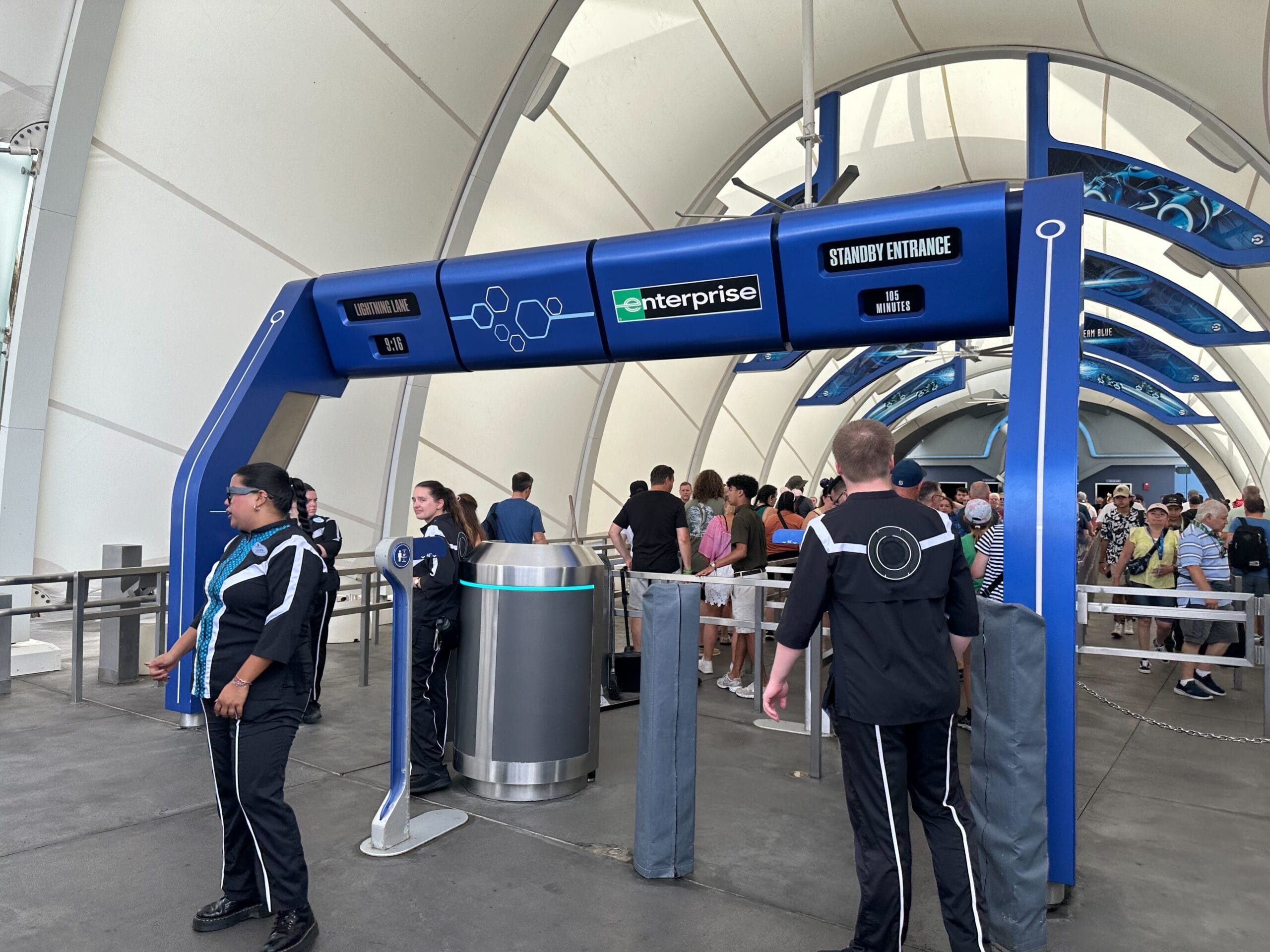 People wait in line for Tron to use lightning Lane single pass
