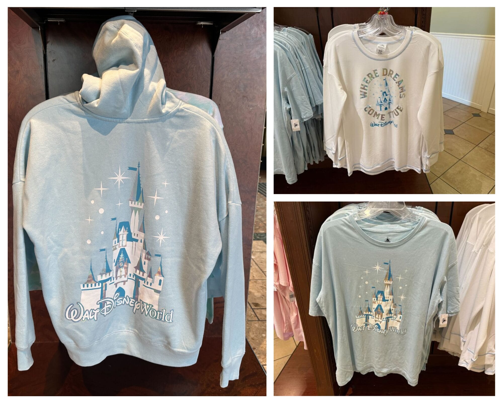 Disney World clothing display: blue hoodie and two white shirts with Magic Kingdom castle-themed clothing and magical text.