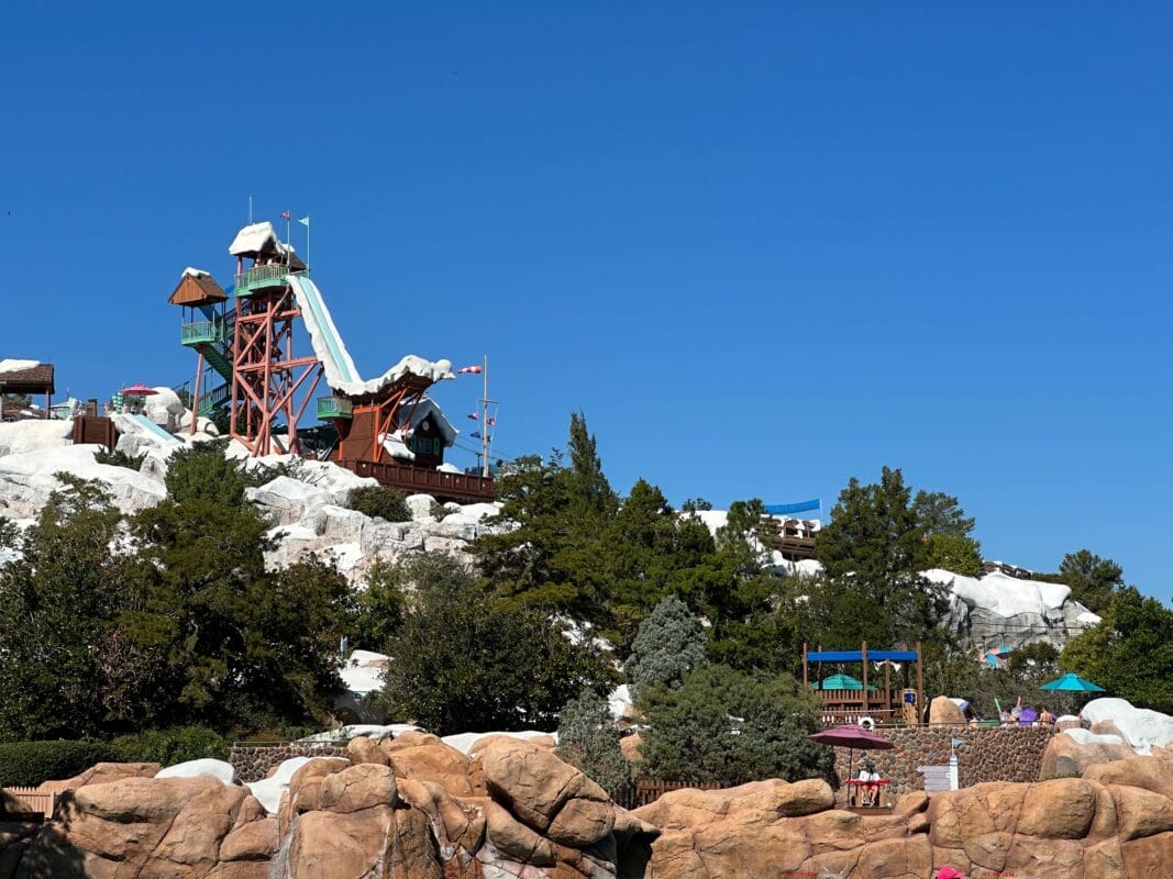 A tall water slide towers over snowy rock structures at Blizzard Beach Disney World