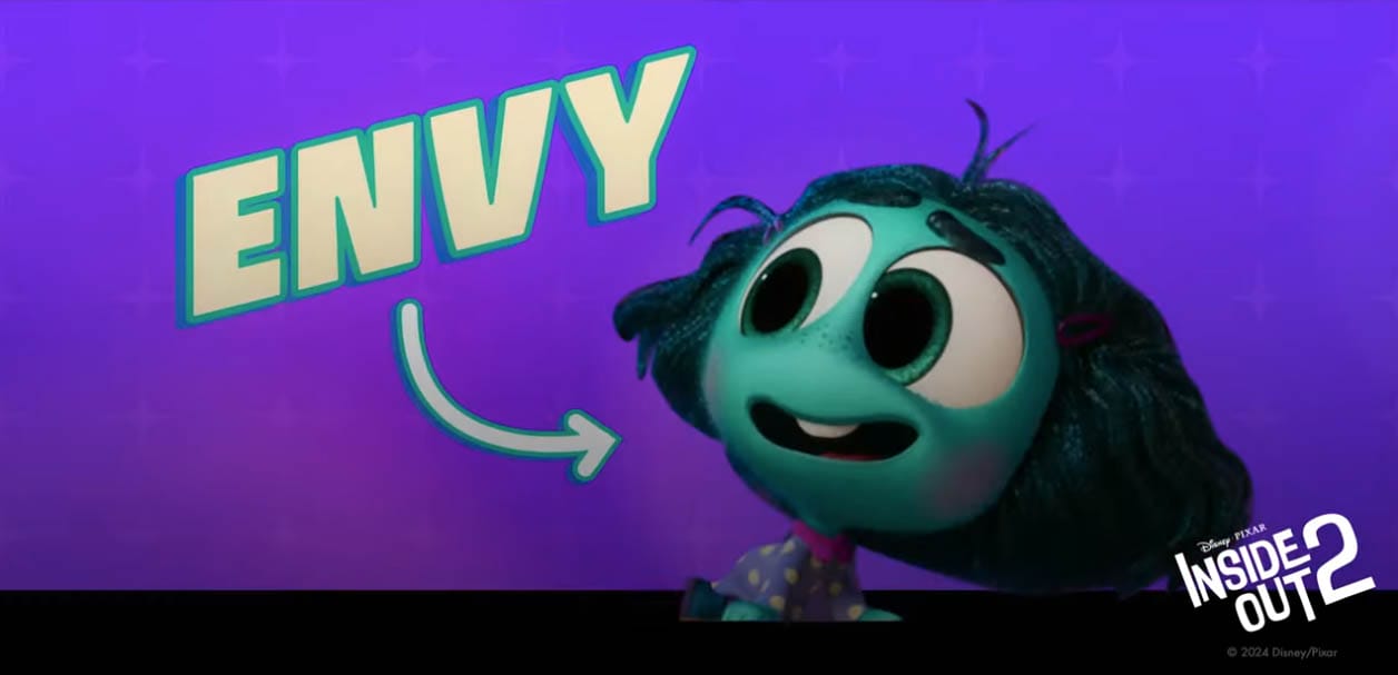 Envy, smiles with wide eyes; "Inside Out 2" logo appears in the corner.