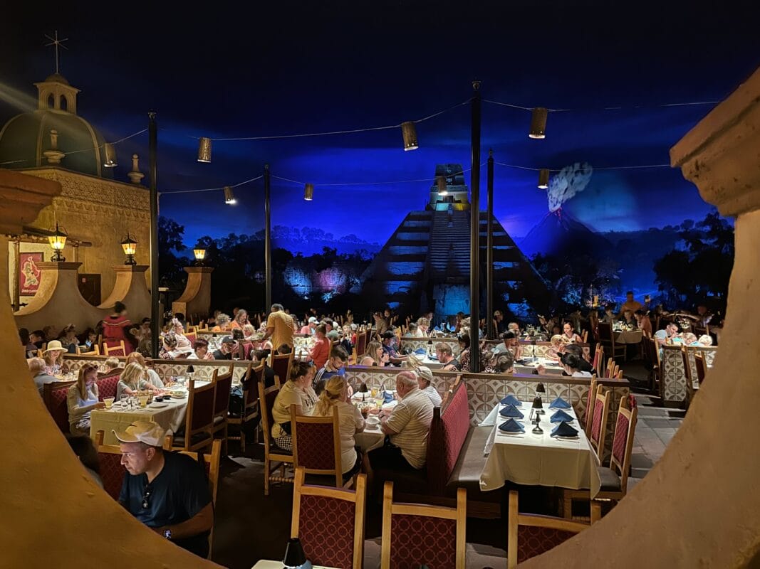 san angel inn EPCOT restaurant, with a nighttime pyramid and volcano backdrop creating a festive, lively atmosphere.
