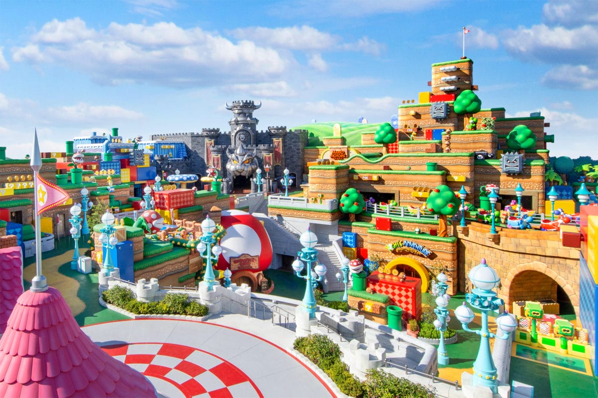 Colorful theme park area at Universal Orlando's Epic Universe, inspired by Super Mario, with blocky hills and a castle. Universal Orlando's Epic Universe super nintendo world