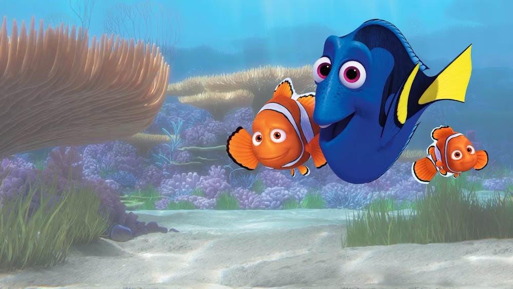 Animated Disney characters Dory, Marlin, and Nemo swim together in a vibrant coral reef underwater scene.
