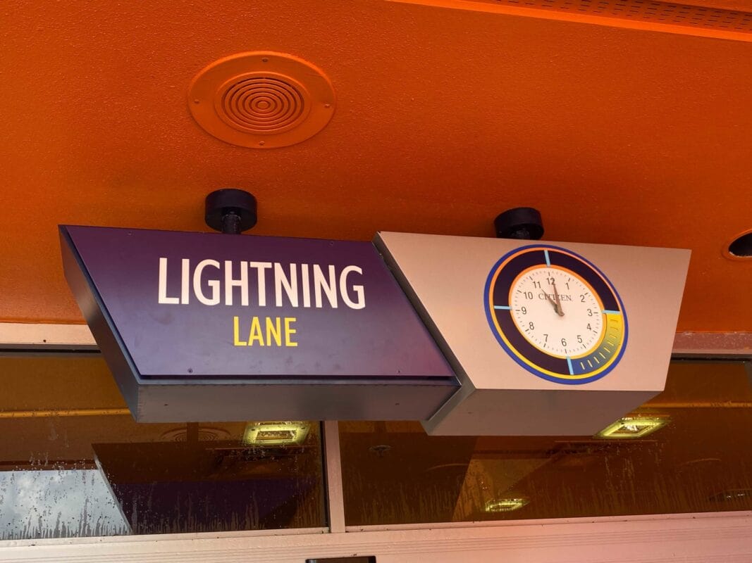 A Lightning Lane Multi Pass sign with a clock 