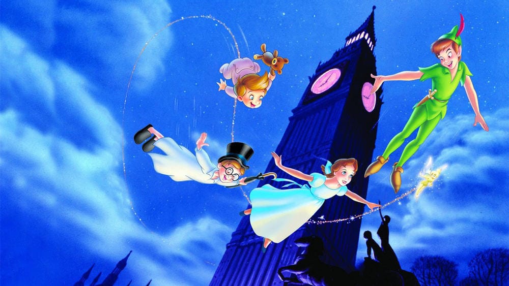 Peter Pan and three children, classic Disney Characters, fly by Big Ben at night leaving sparkling trails in the sky.